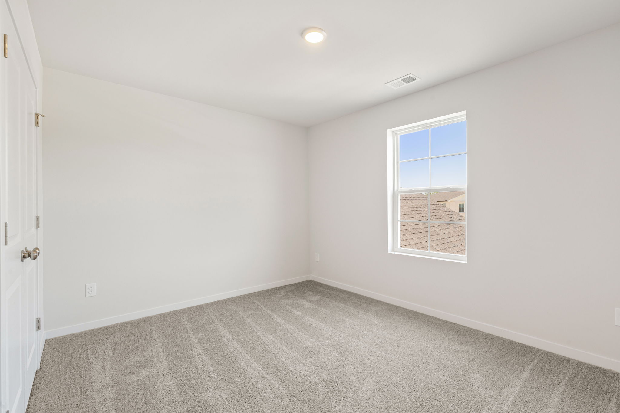 A room with a window and a door.