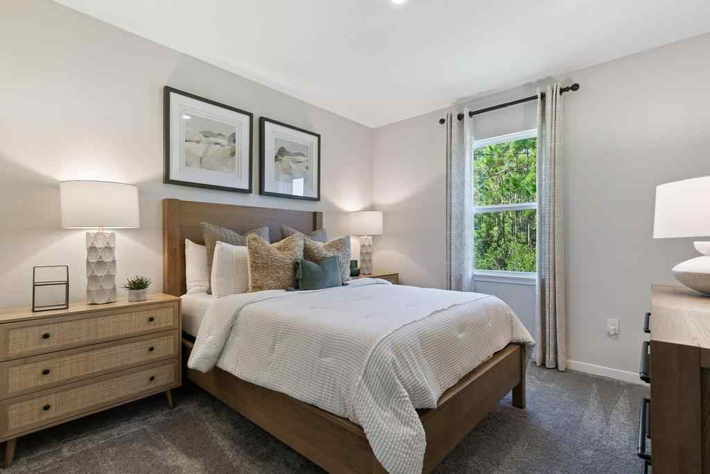 A bedroom with a bed and lamps.