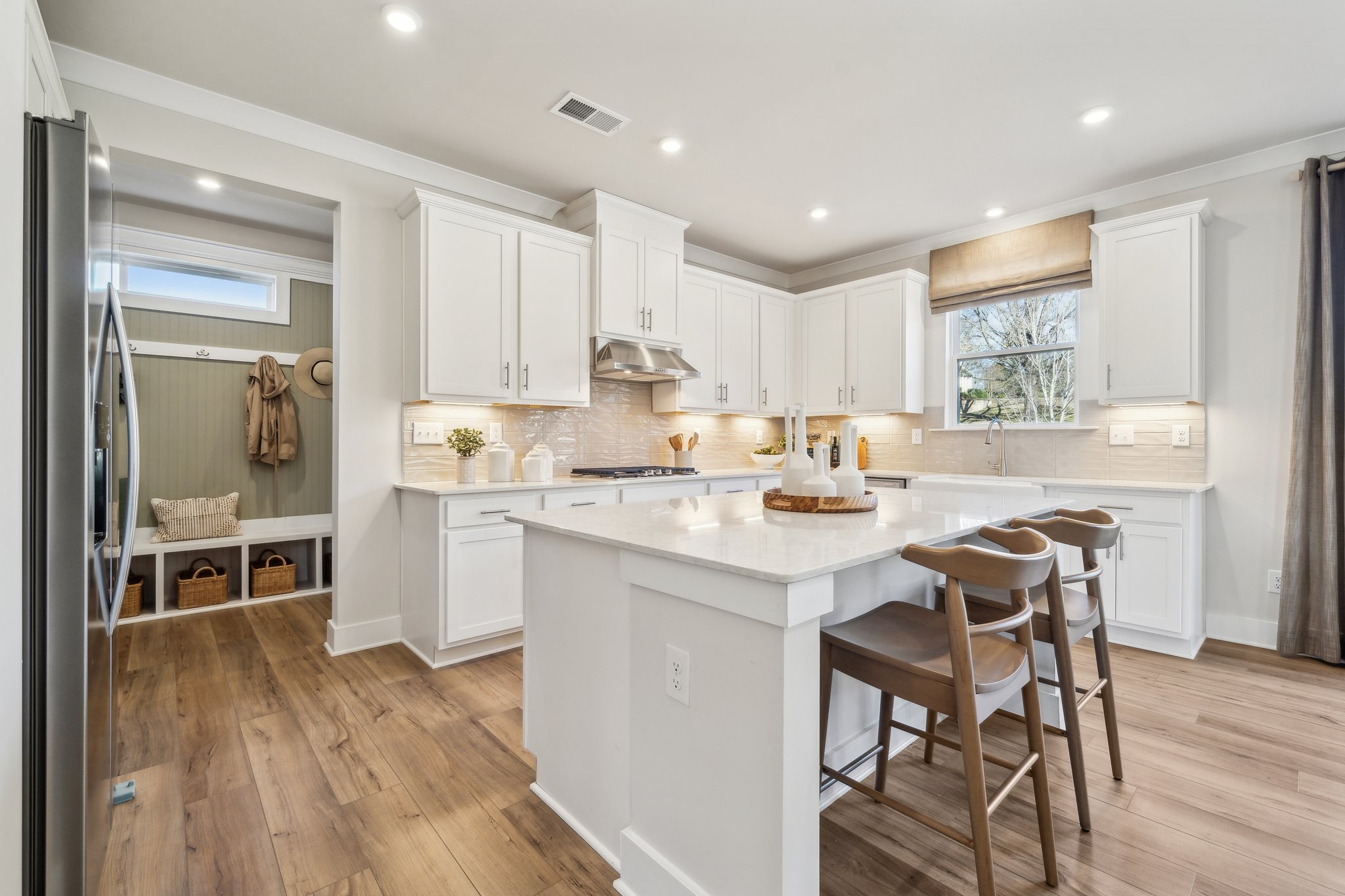 A kitchen with white cabinets.
