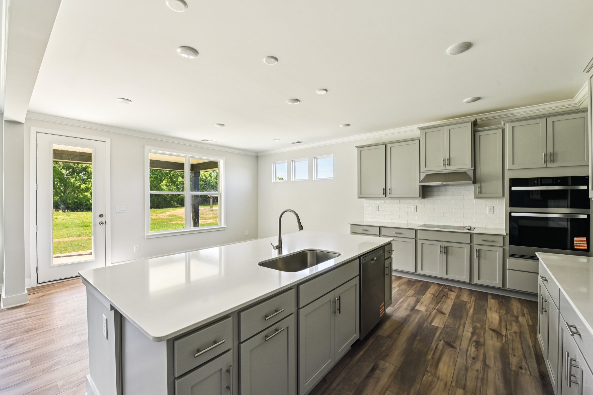 A kitchen with white cabinets.