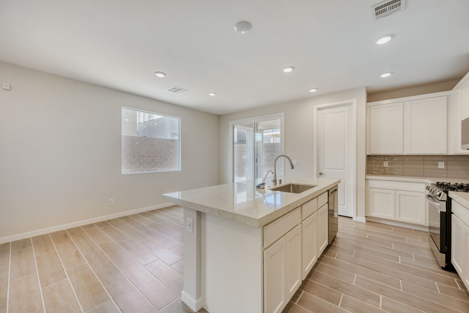 A kitchen with white cabinets.