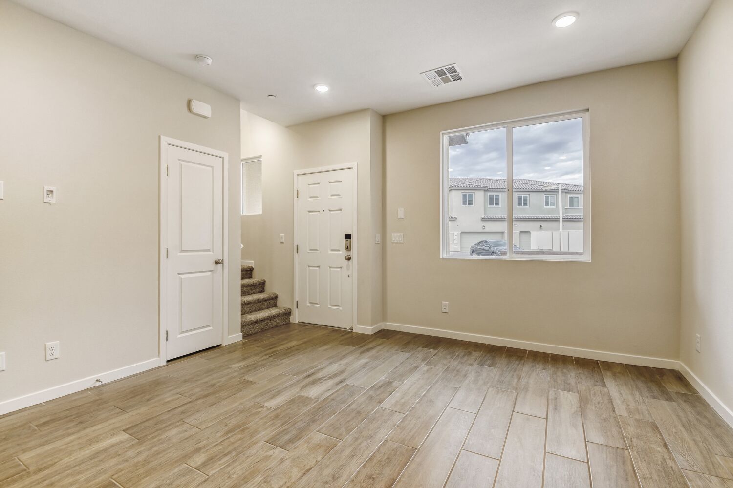 A room with white doors and a window.
