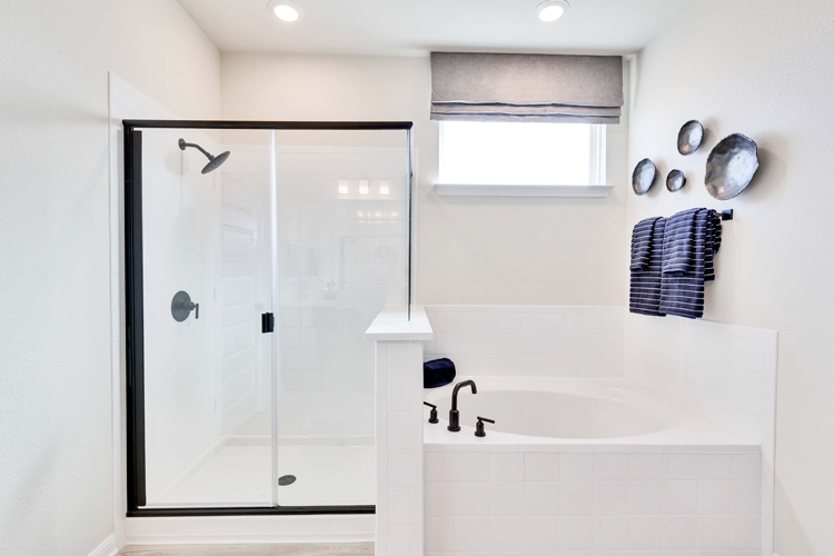 A bathroom with a tub and shower.