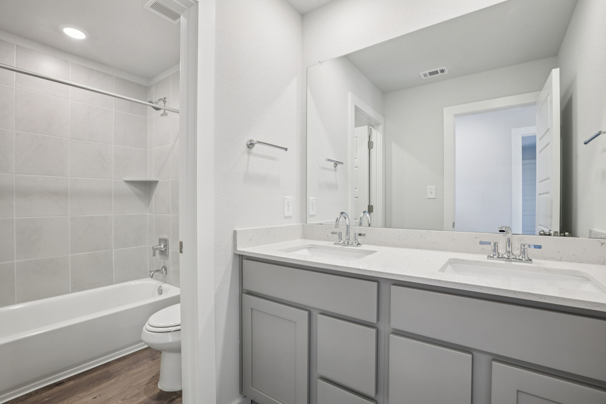 A bathroom with a tub sink and toilet.
