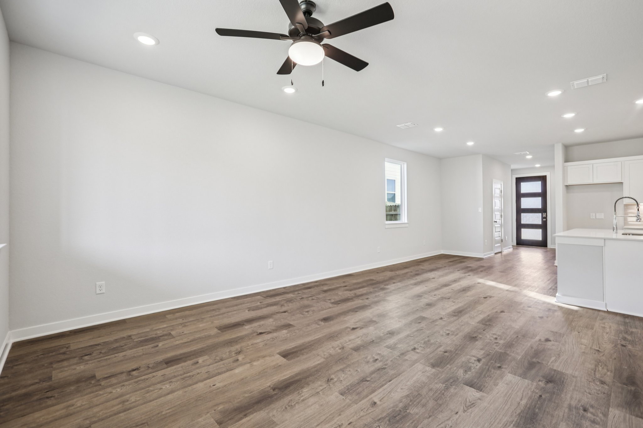 A kitchen with a wood floor.