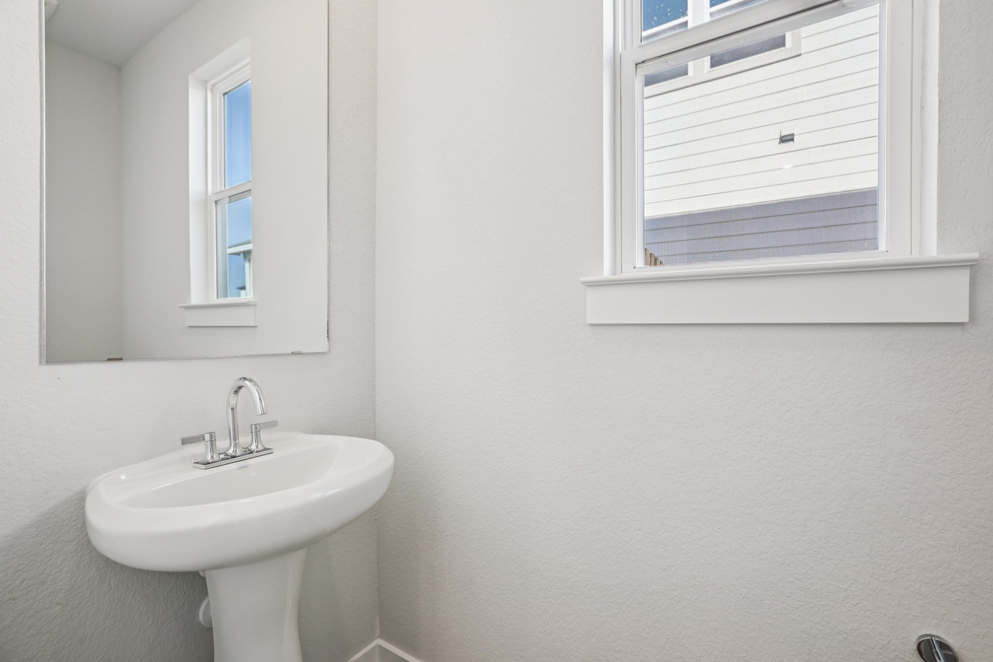 A bathroom with a sink and a window.