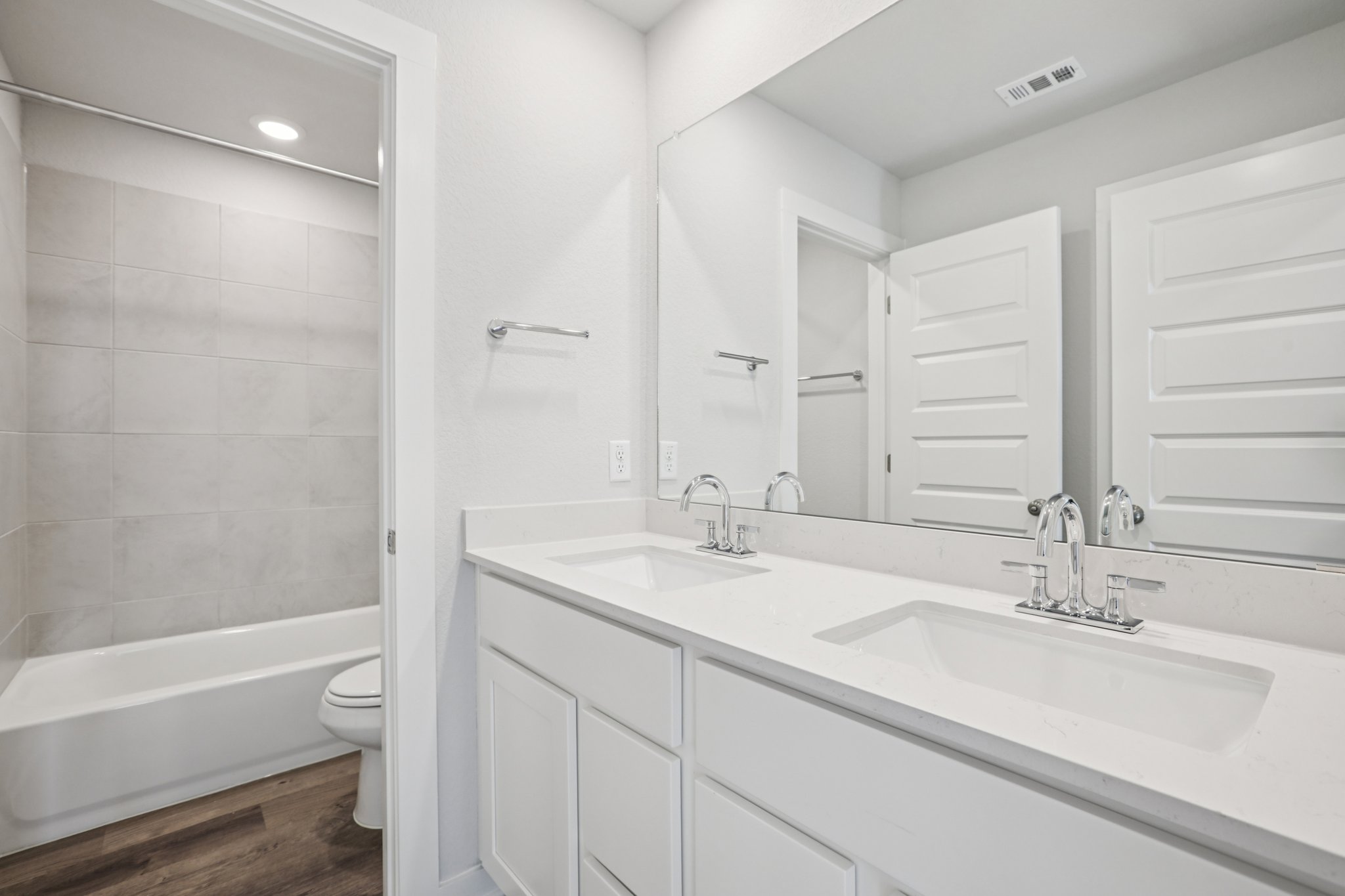 A bathroom with a tub sink and toilet.