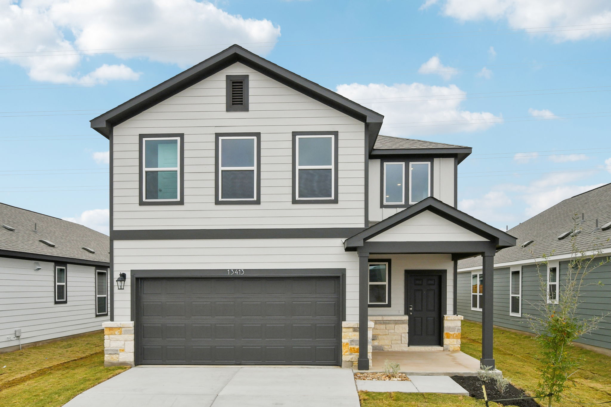 A grey house with a garage.