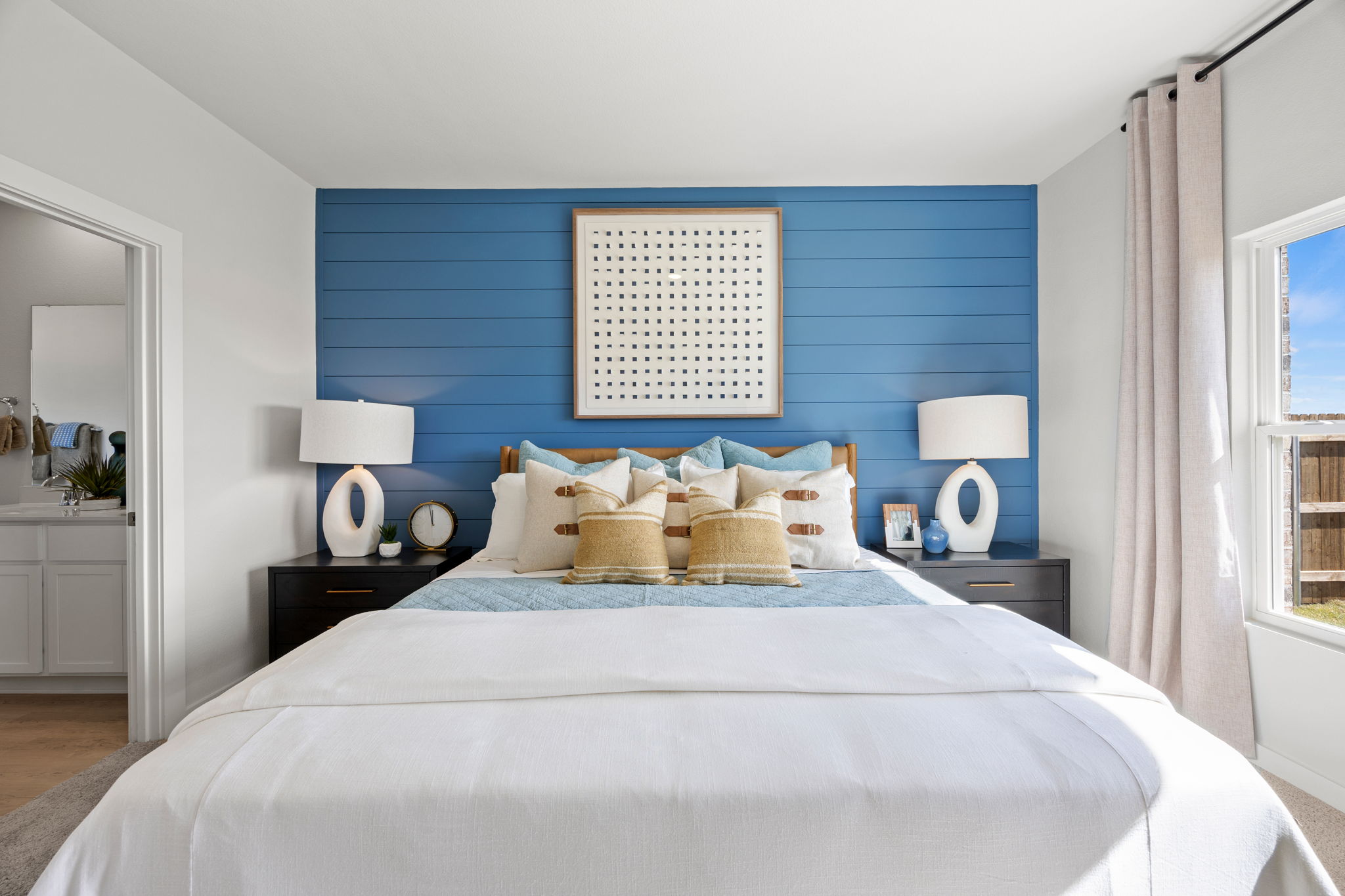 A bedroom with a blue wall.