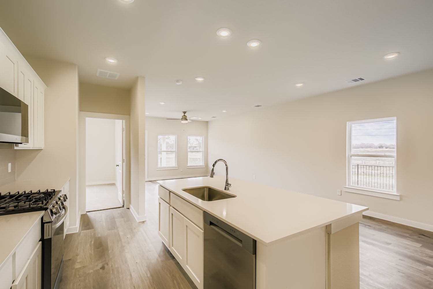 A kitchen with white cabinets.