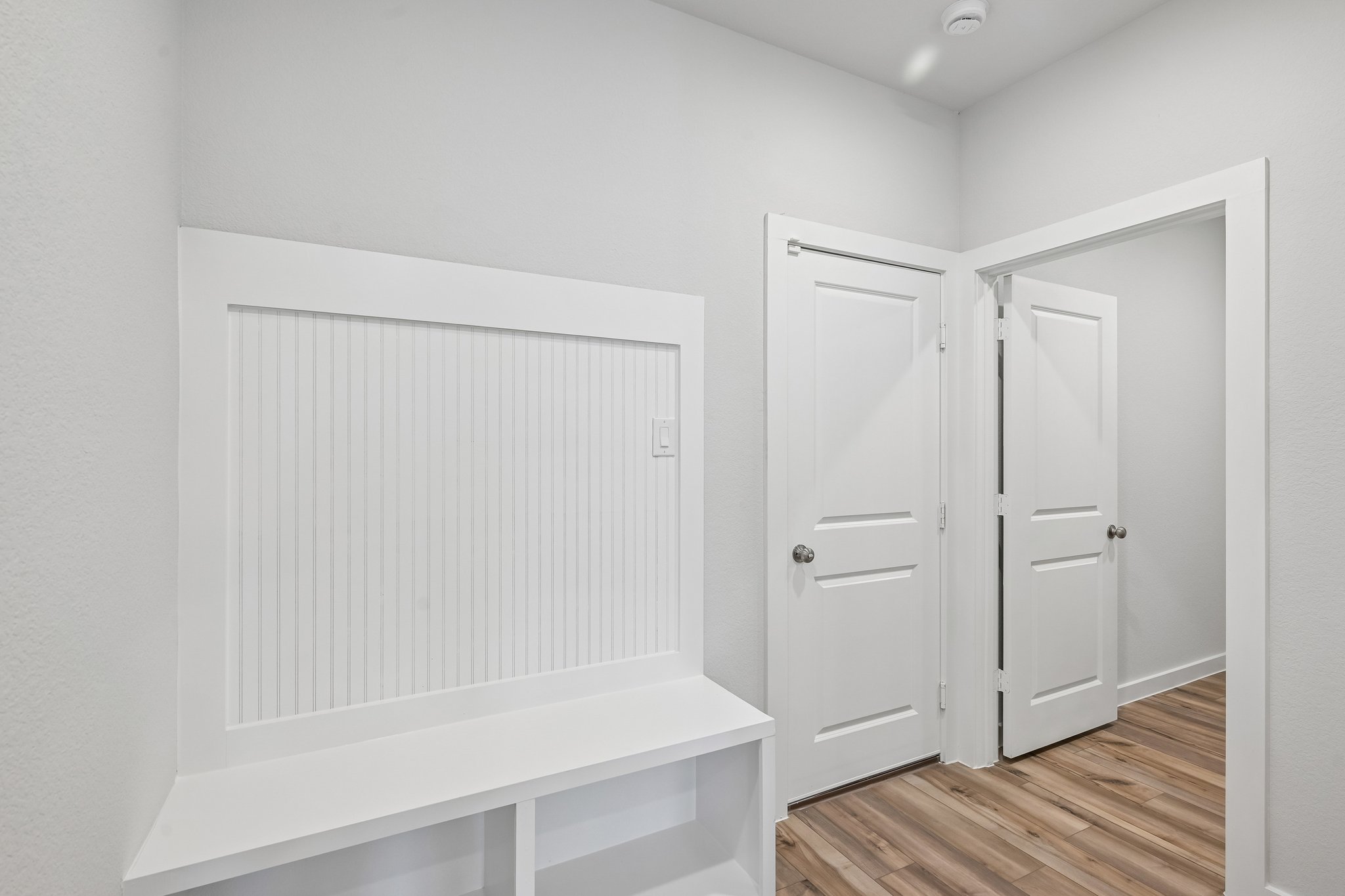A white room with white doors.