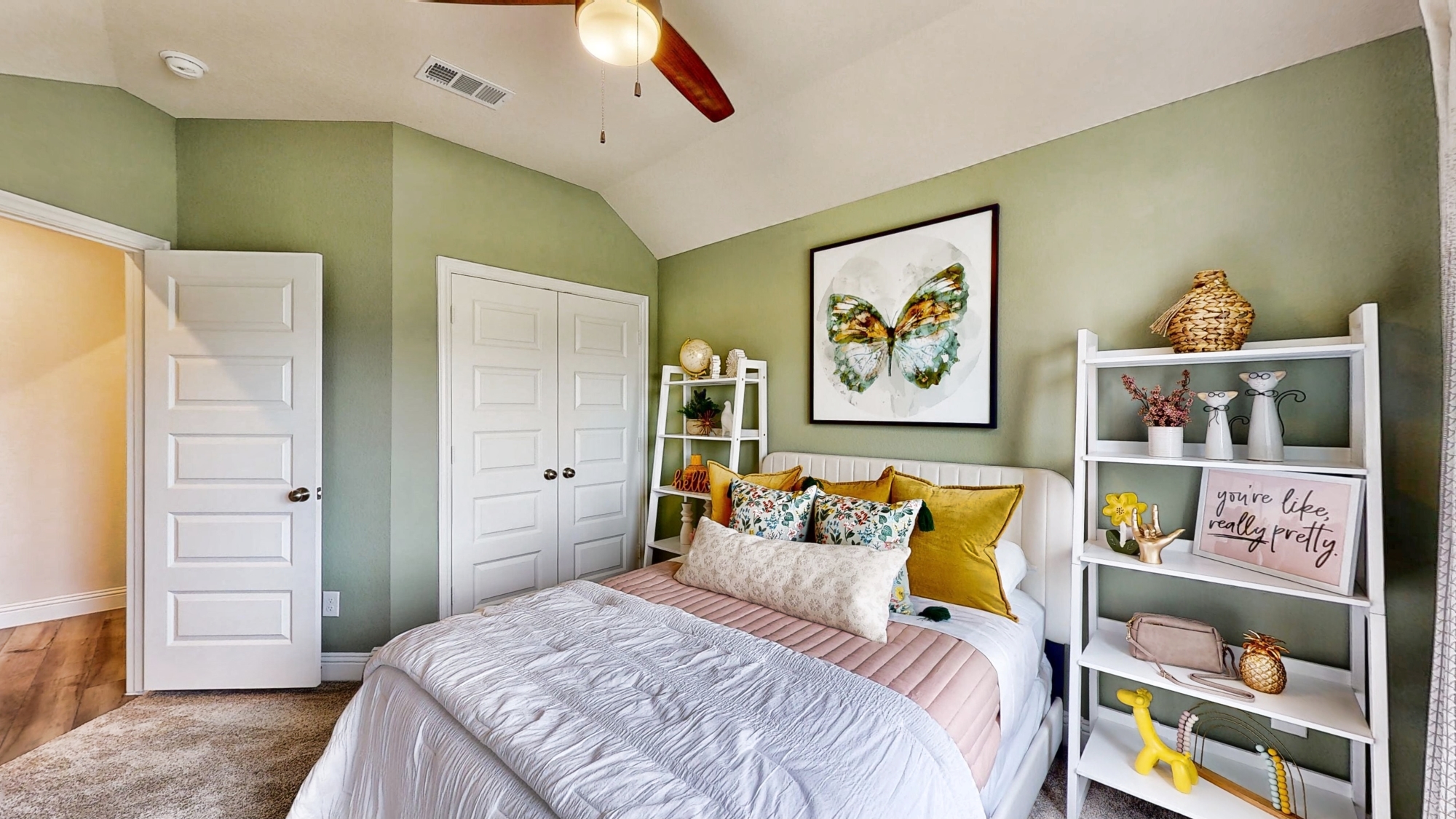 A bedroom with a bed and a shelf.