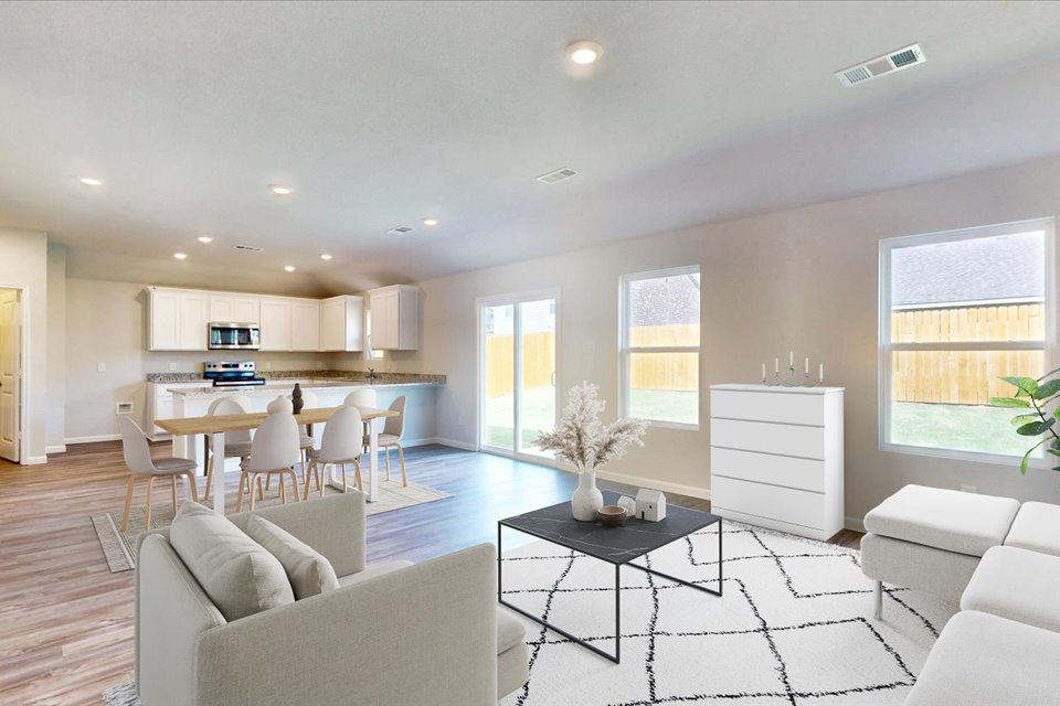 A large living room with a dining table and couches.