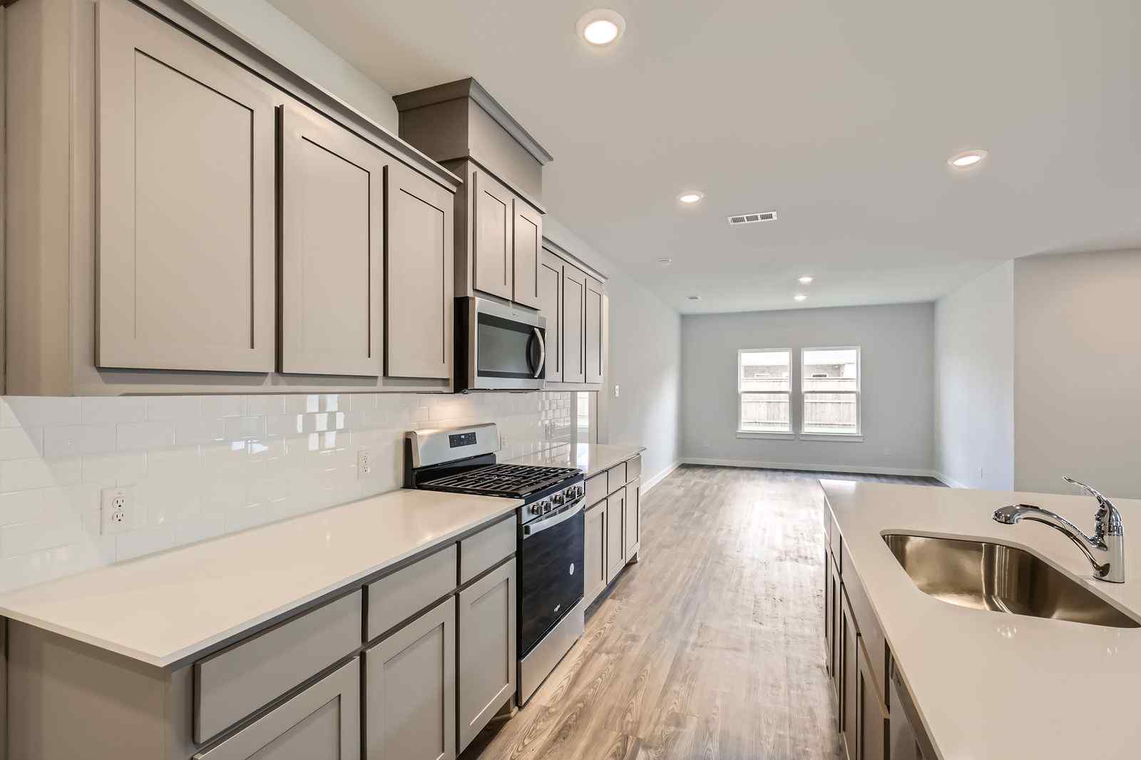 A kitchen with white cabinets.