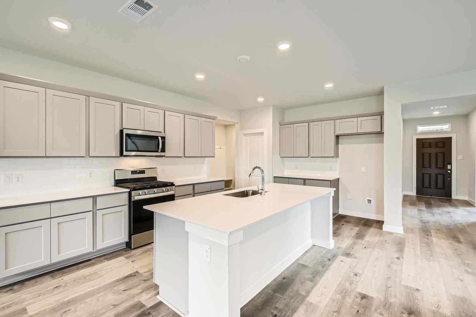 A kitchen with white cabinets.