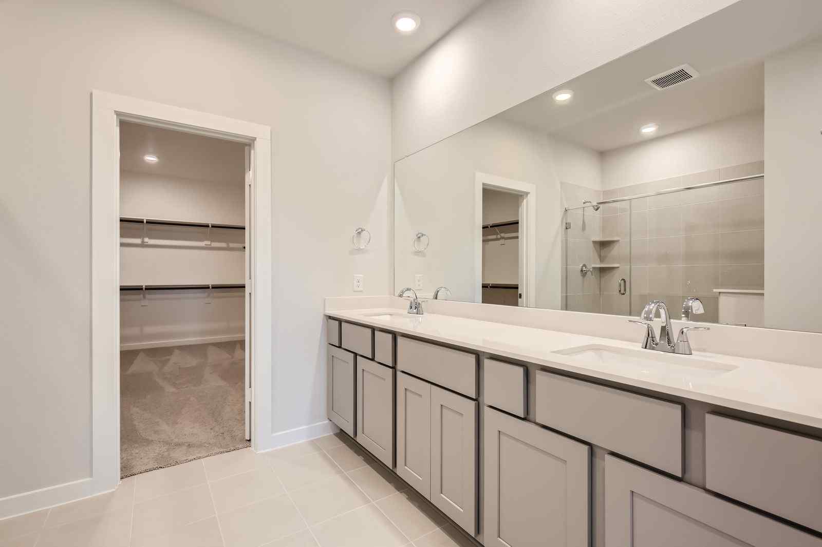 A bathroom with a large mirror.