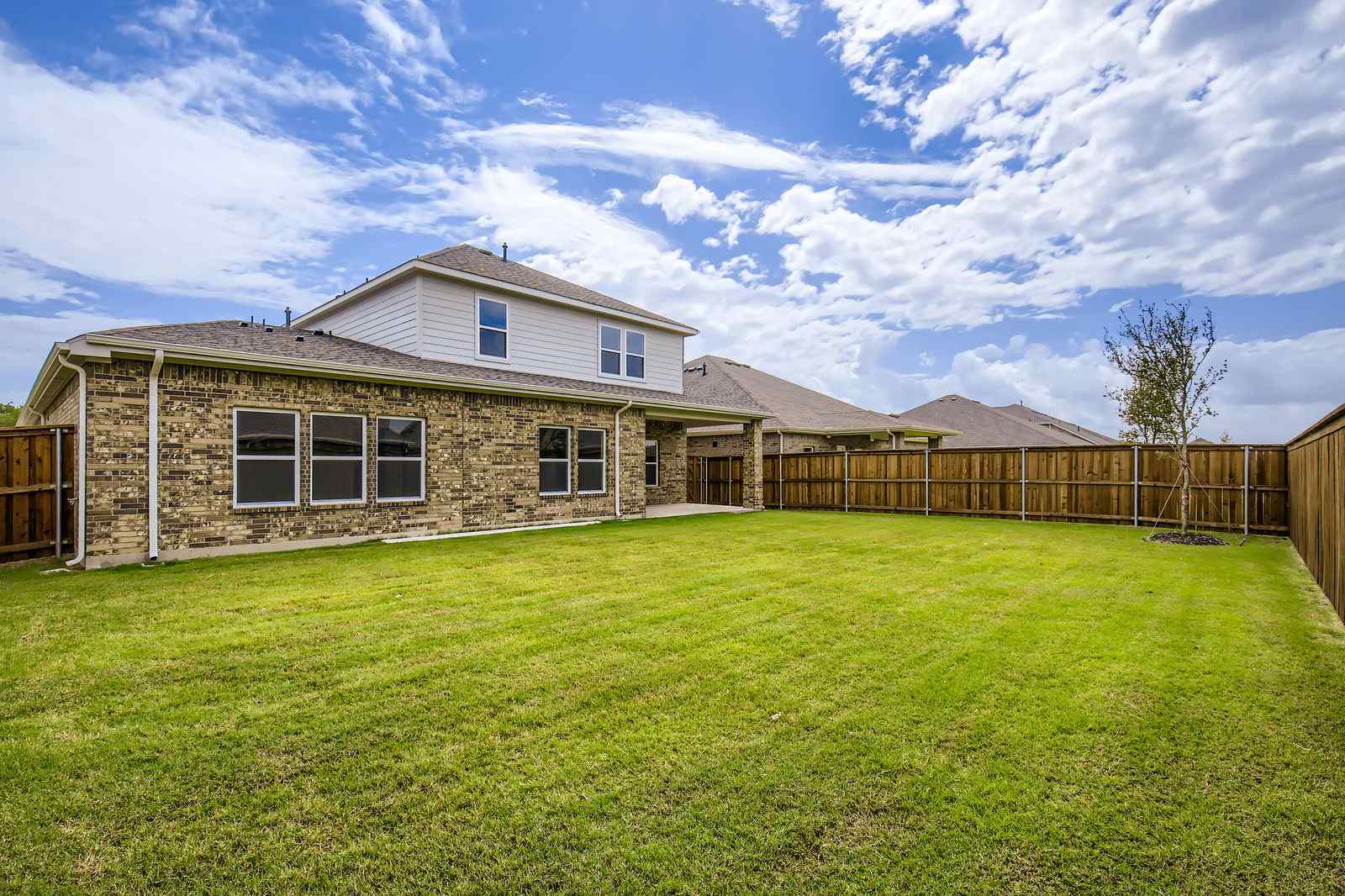 A house with a fence and grass.
