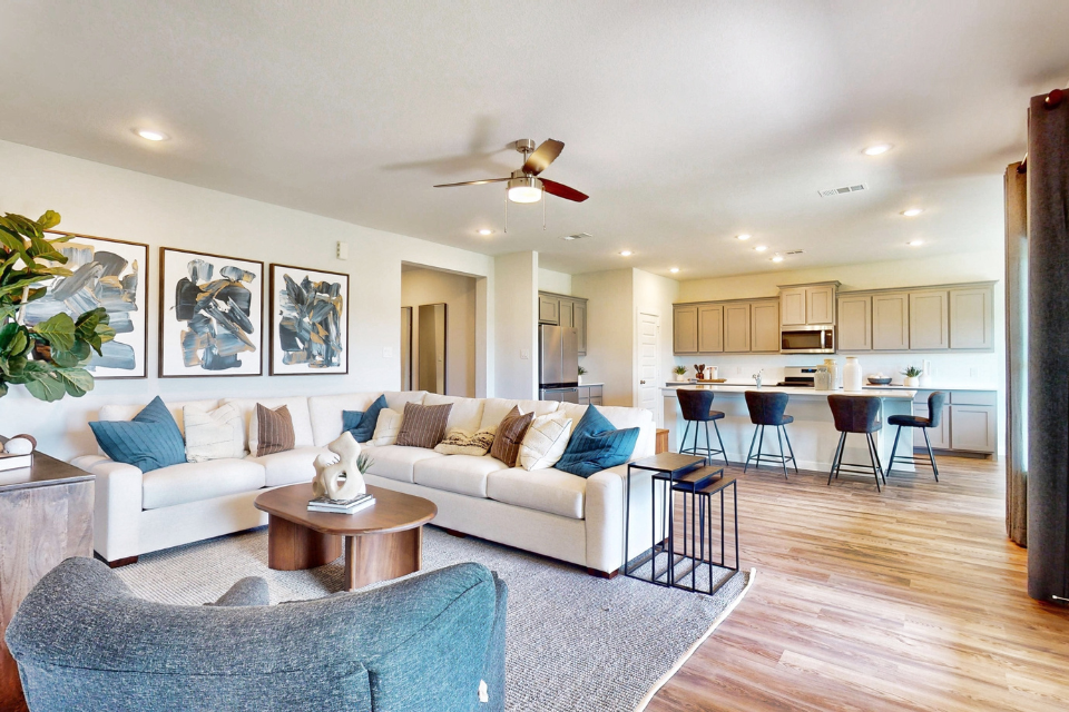 A living room with a white couch and a table.