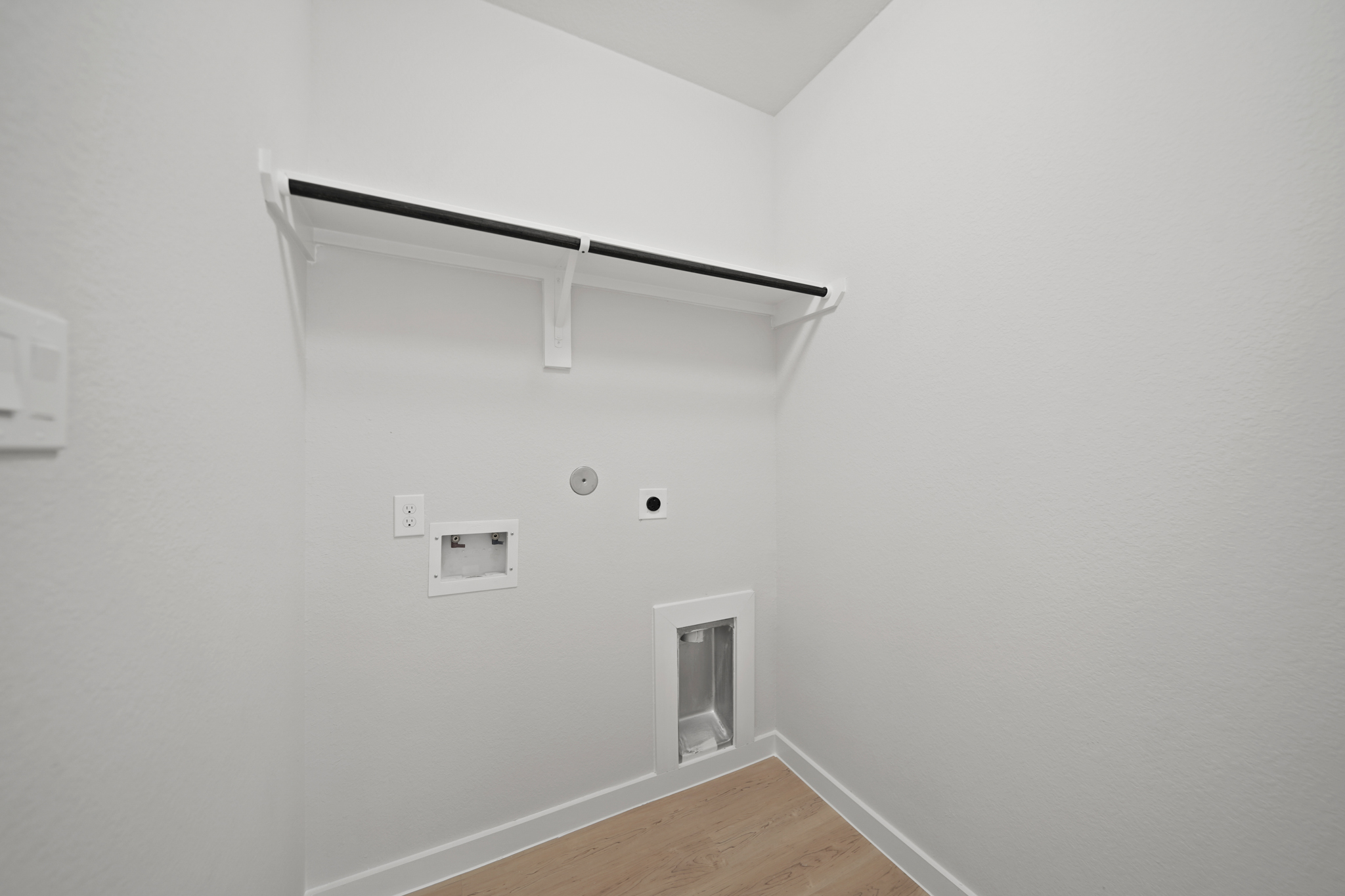 A white wall with a light fixture.