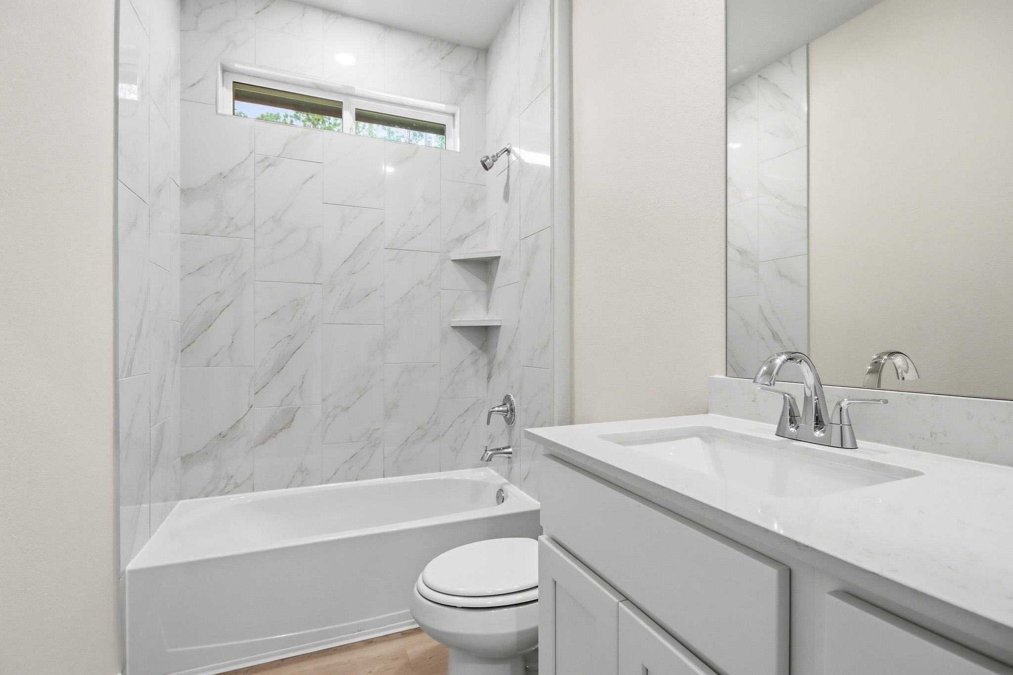 A bathroom with a tub sink and toilet.