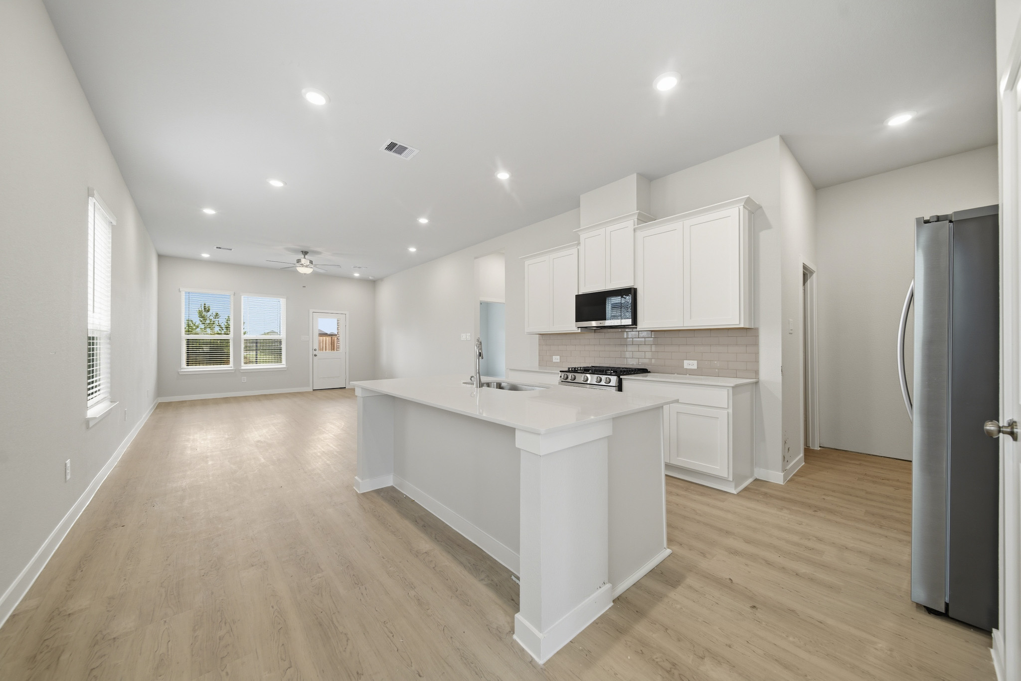 A kitchen with white cabinets.