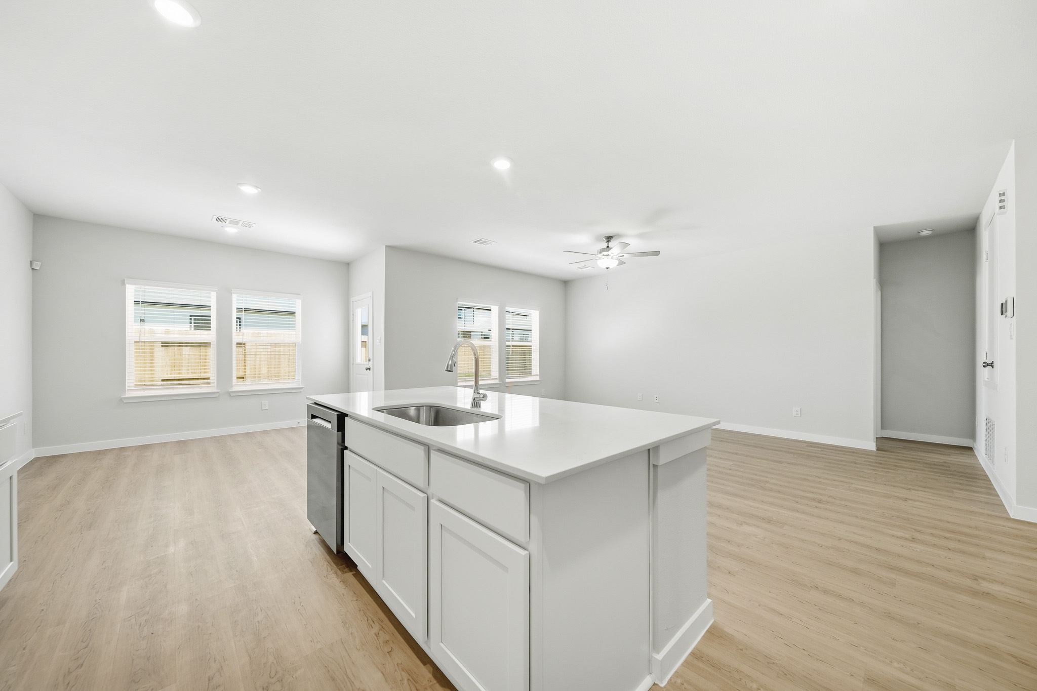 A kitchen with white cabinets.