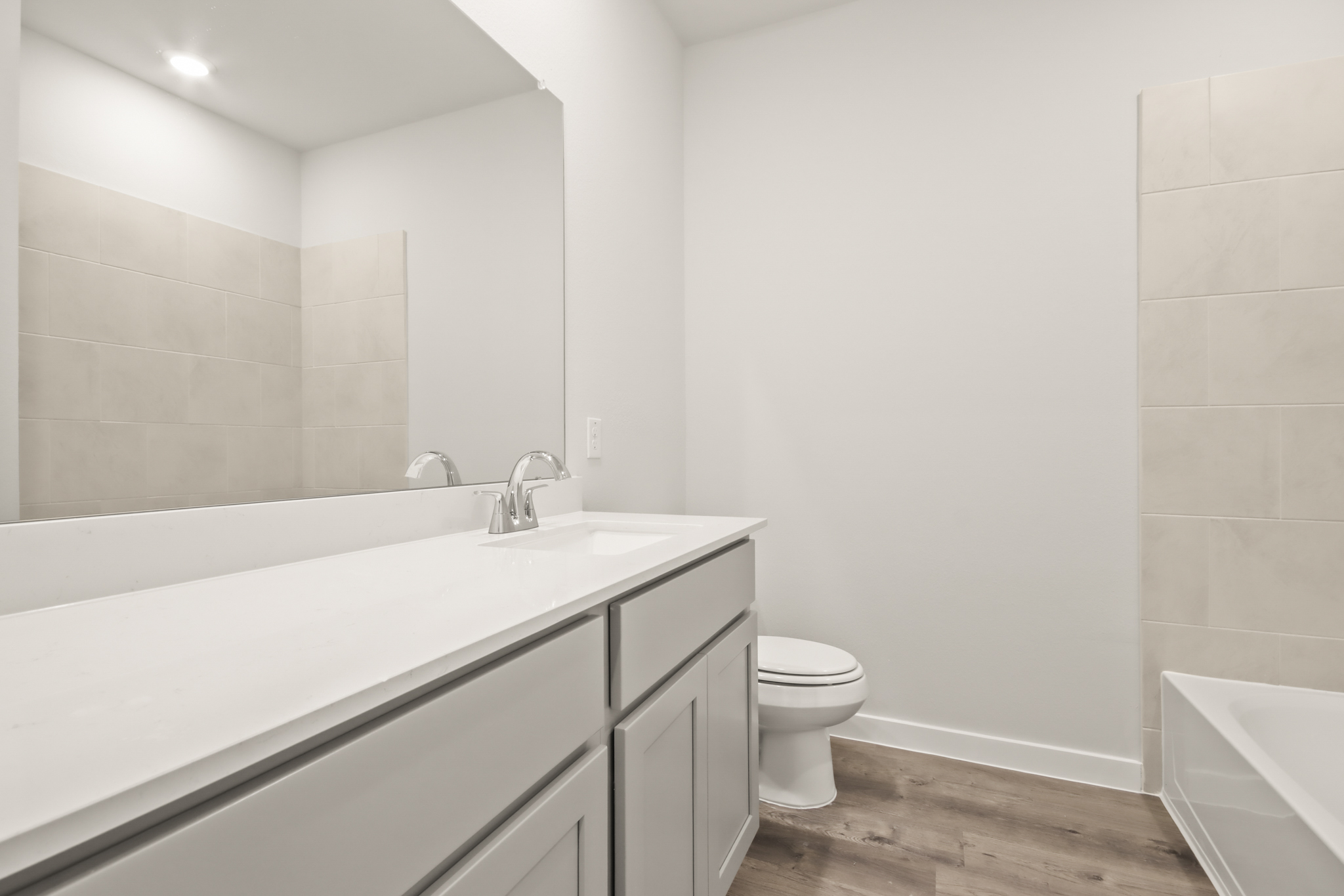 A bathroom with a tub sink and toilet.