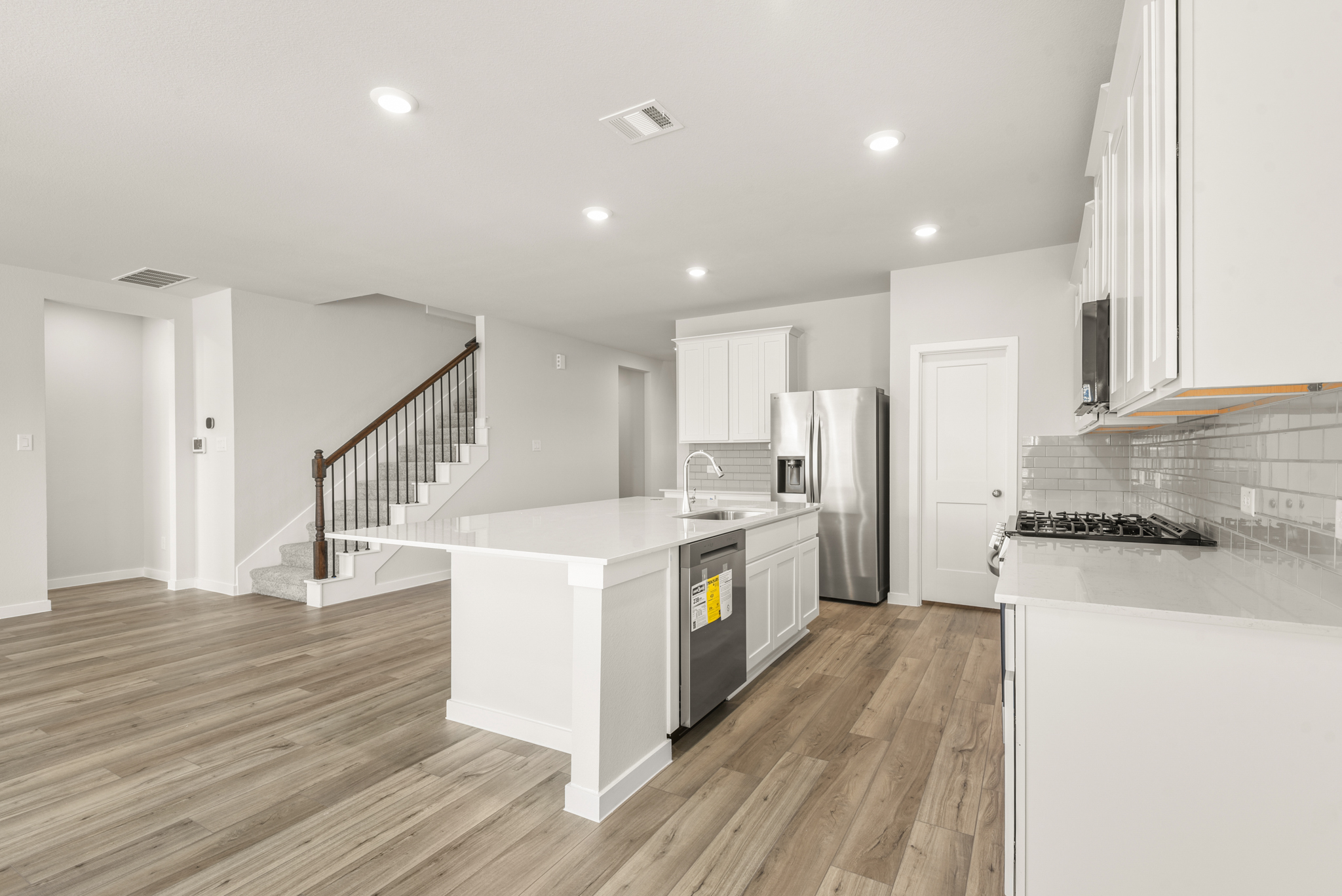 A kitchen with white cabinets.