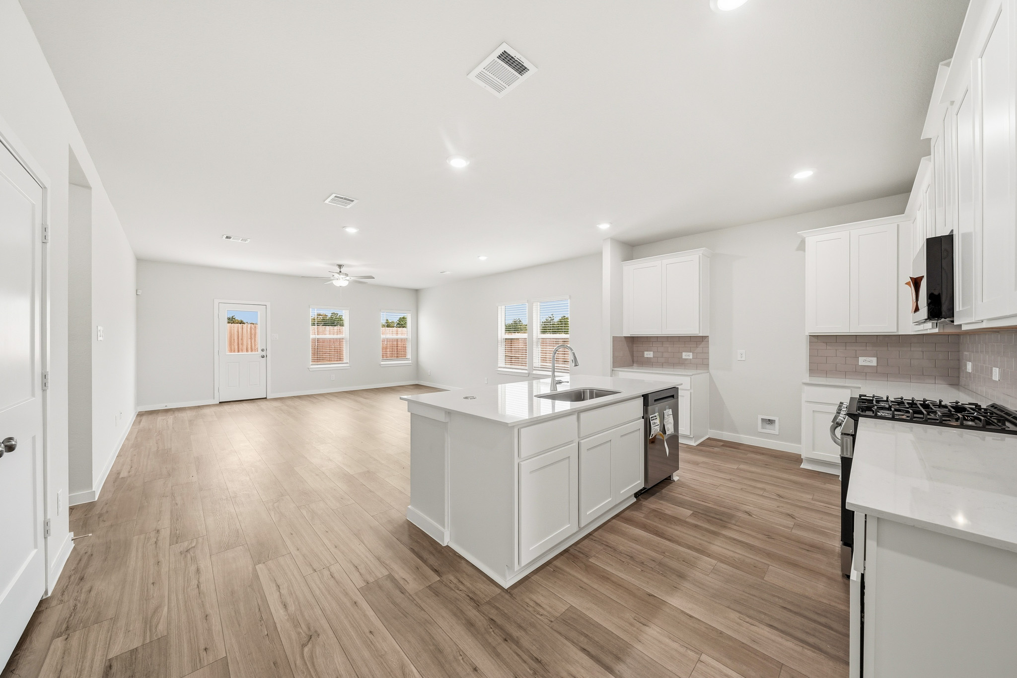 A large kitchen with white cabinets.