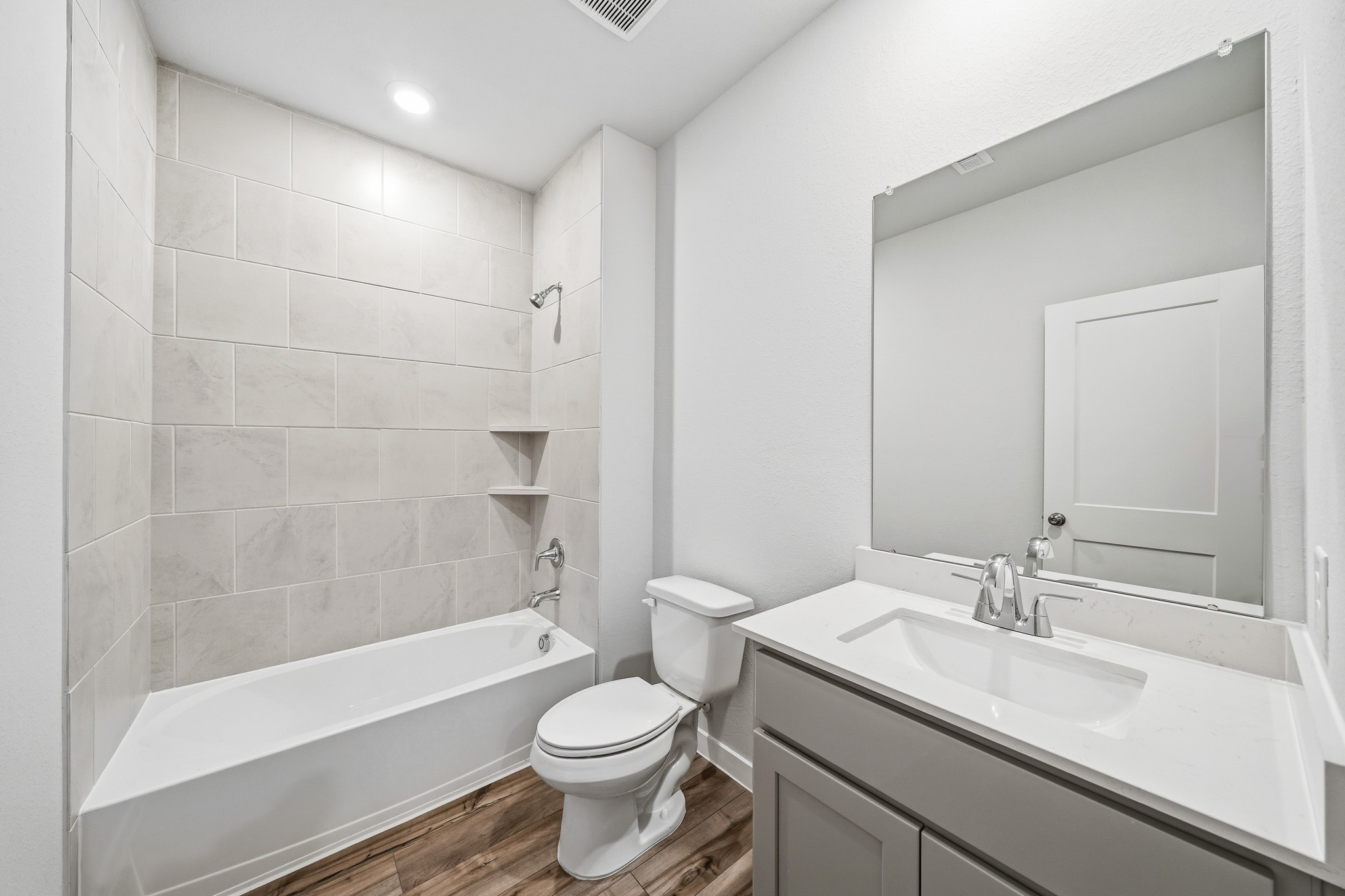 A bathroom with a tub toilet and sink.
