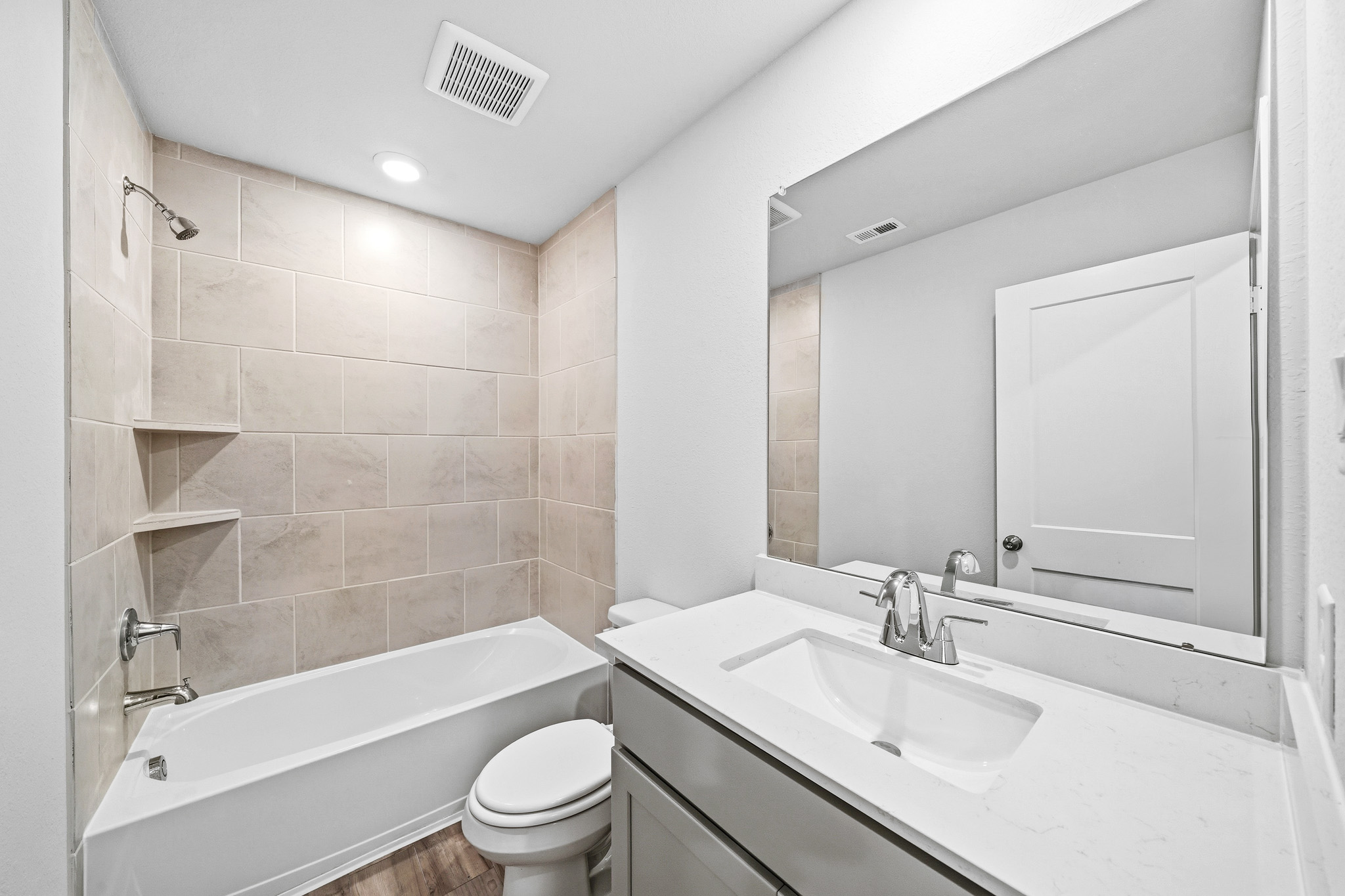 A bathroom with a tub sink and toilet.