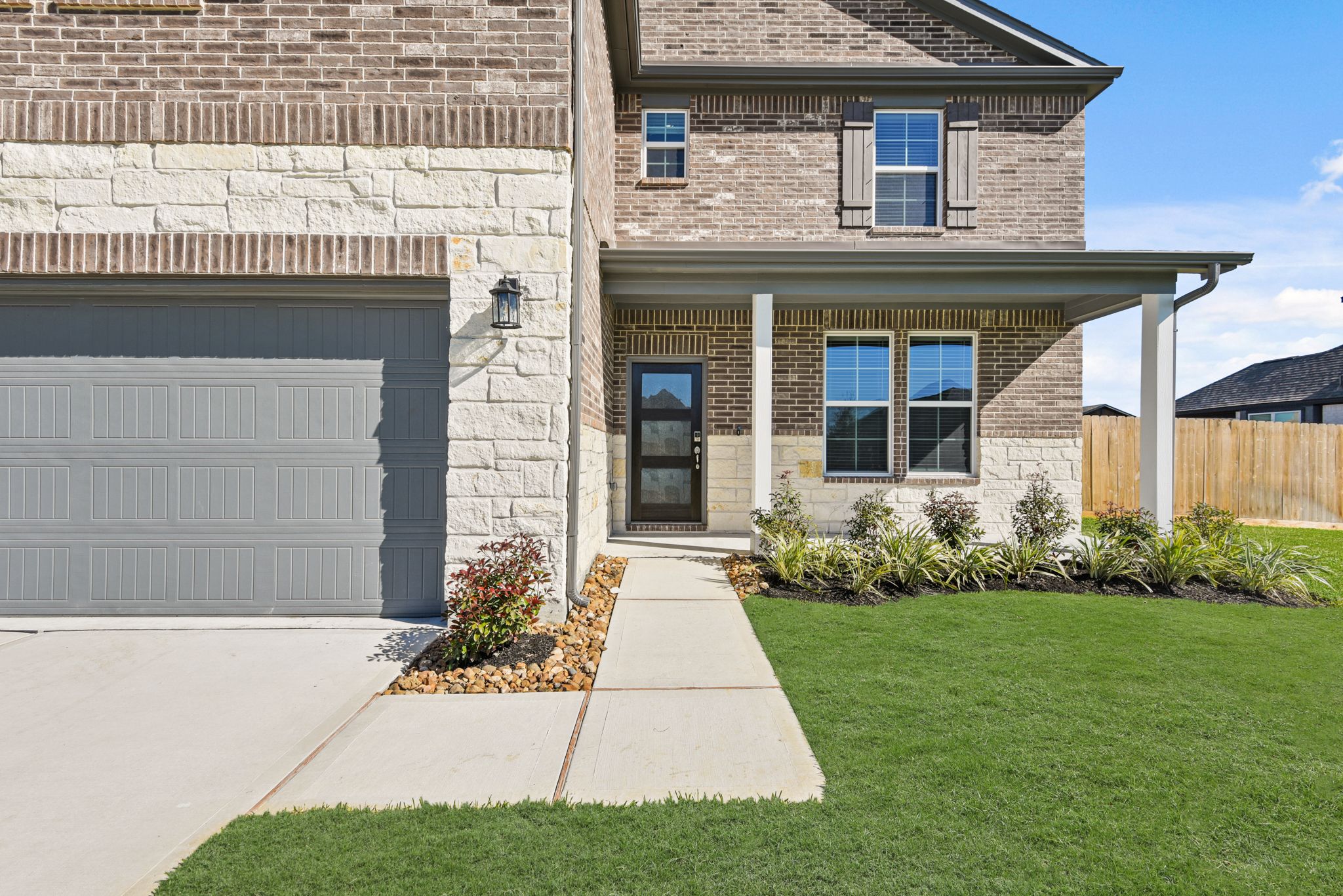 A house with a garage and a lawn.