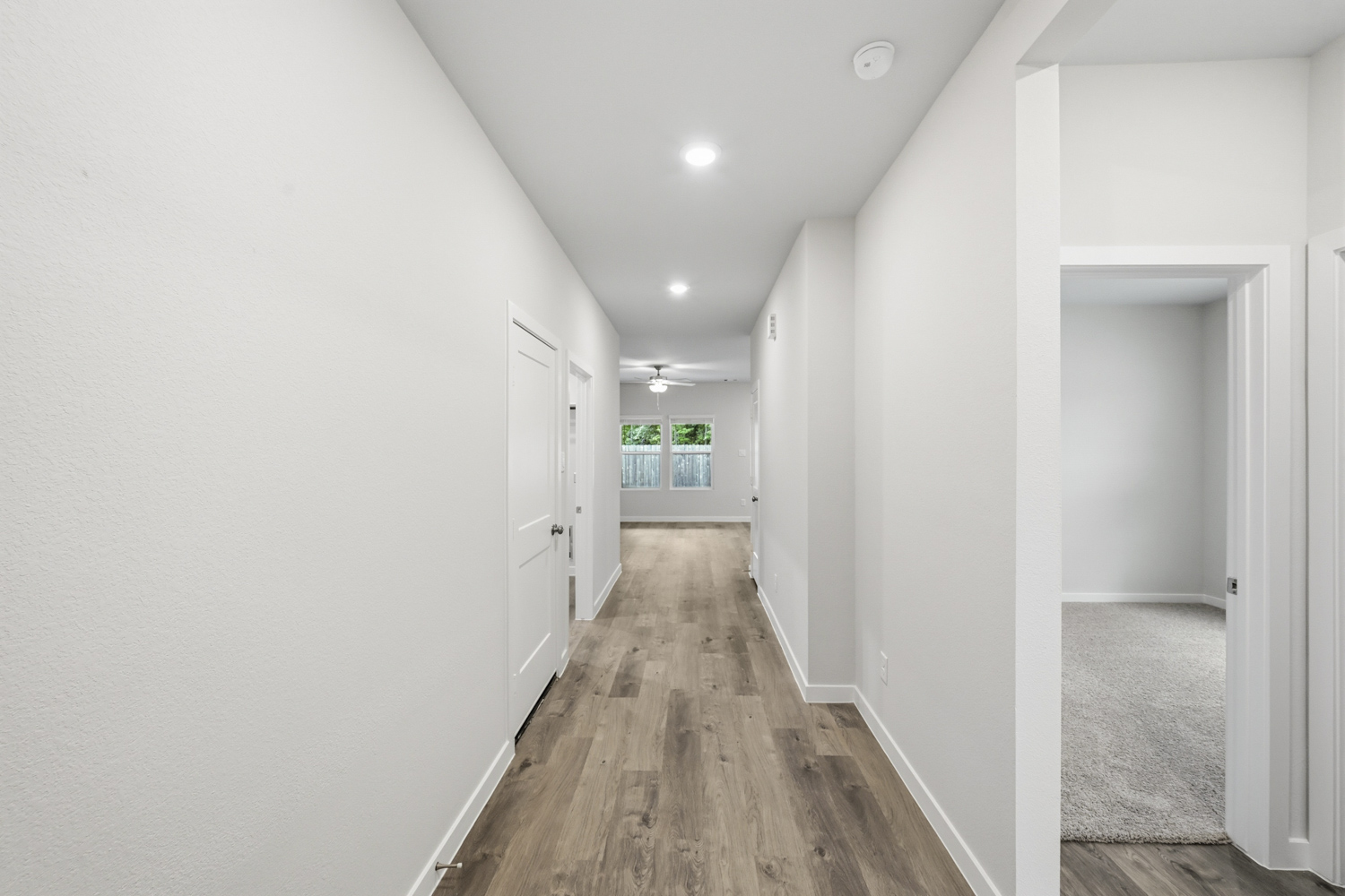 A hallway with white walls.