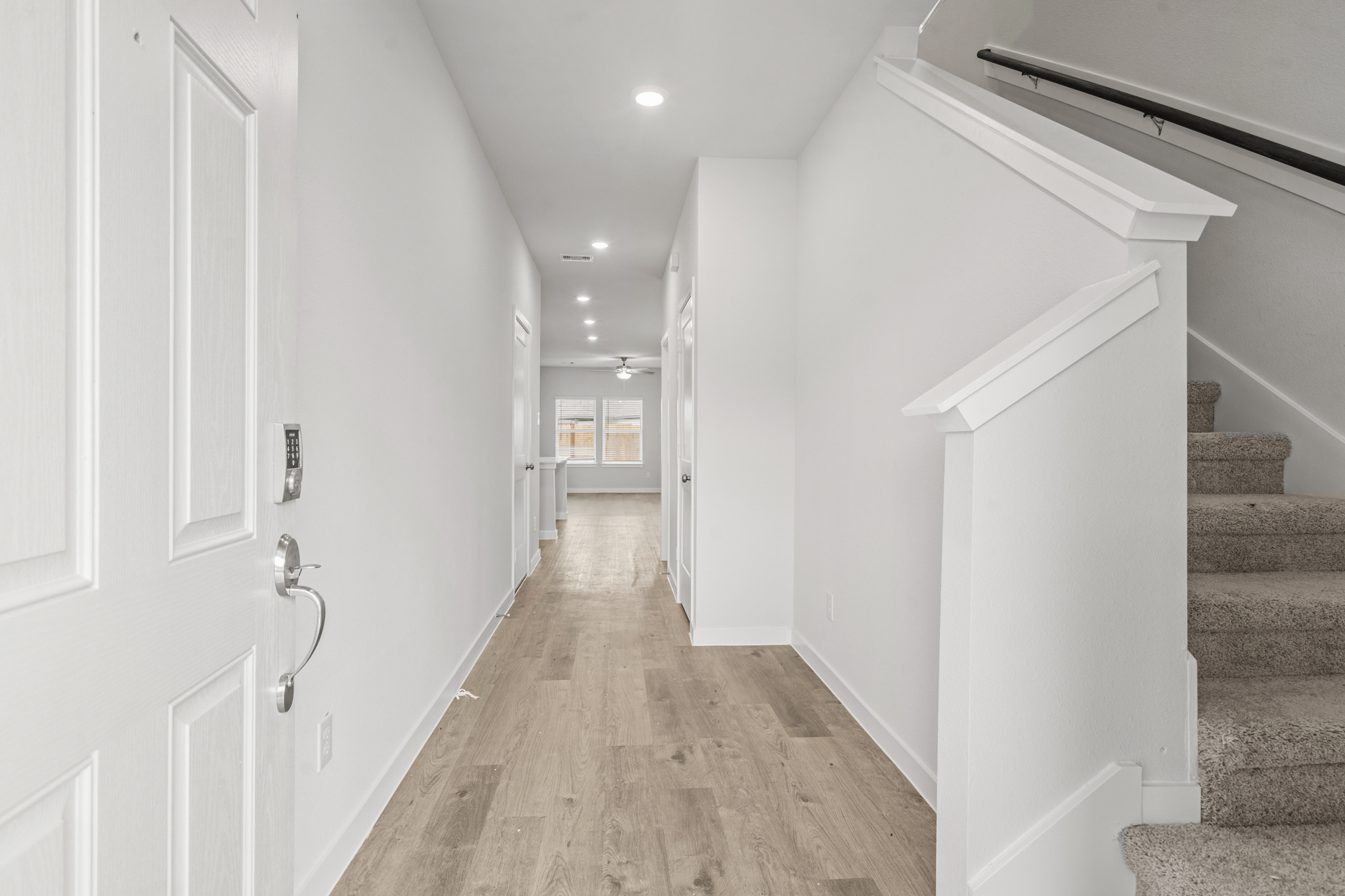A hallway with white walls.