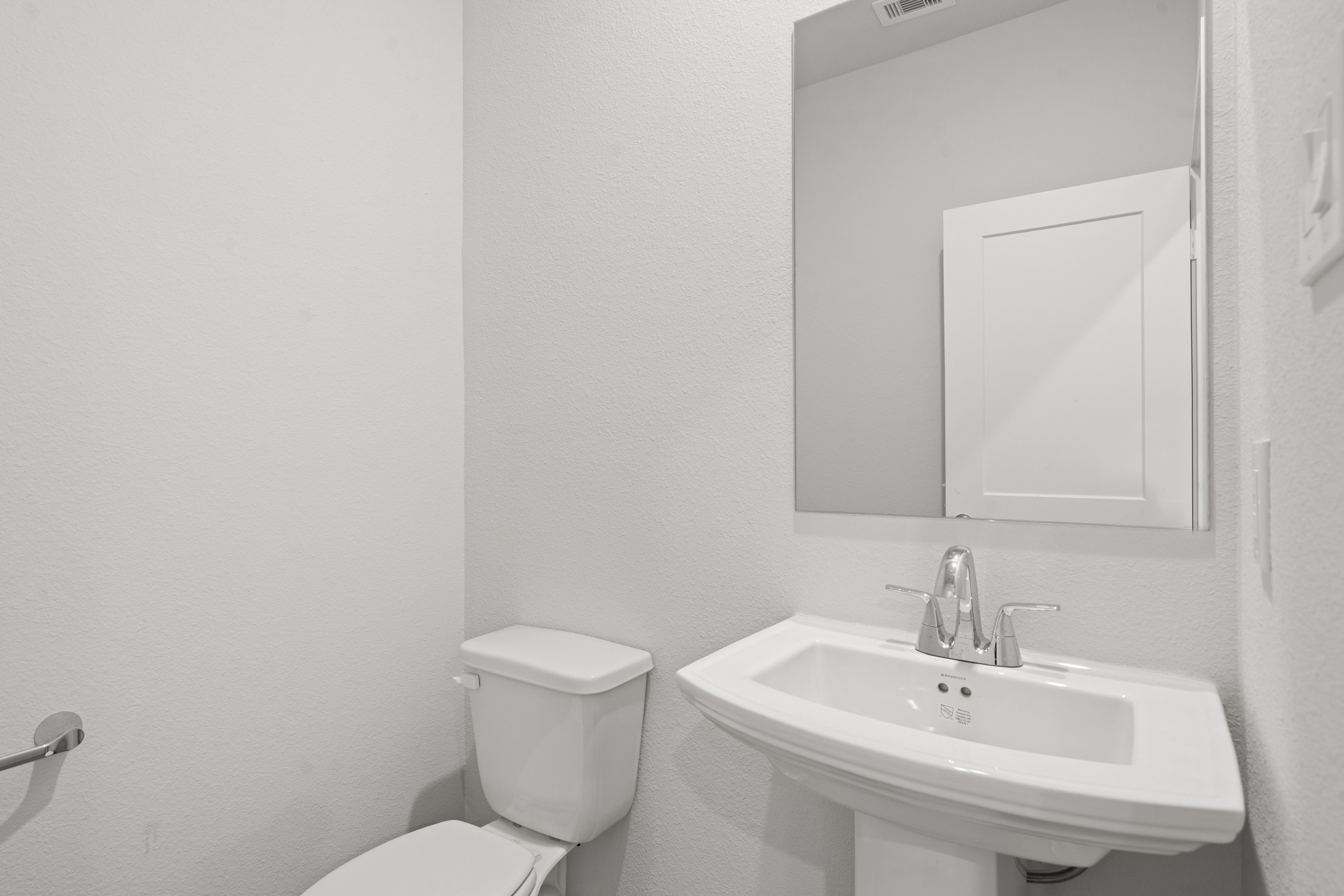 A bathroom with a sink and toilet.
