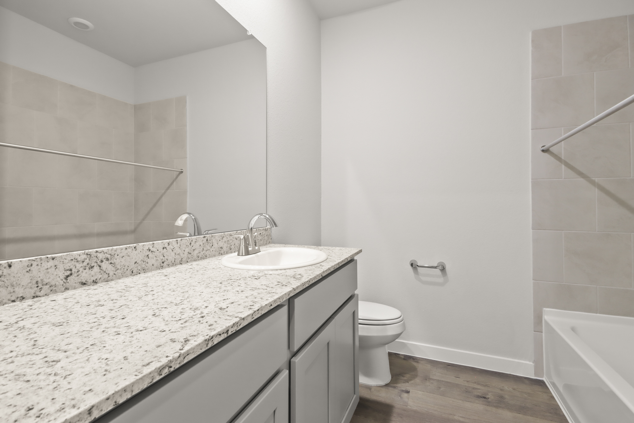 A bathroom with a marble countertop.