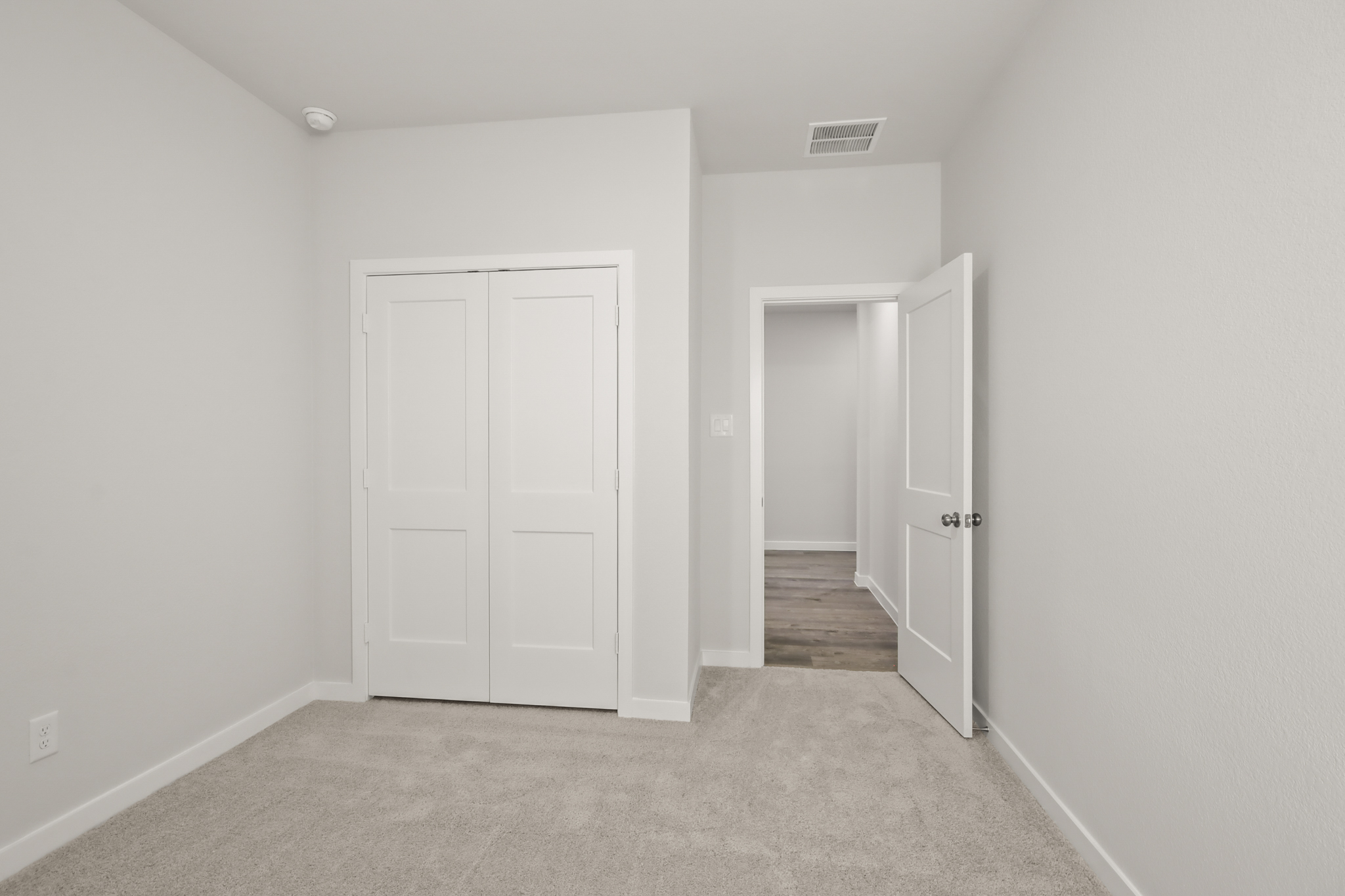 A hallway with white doors.