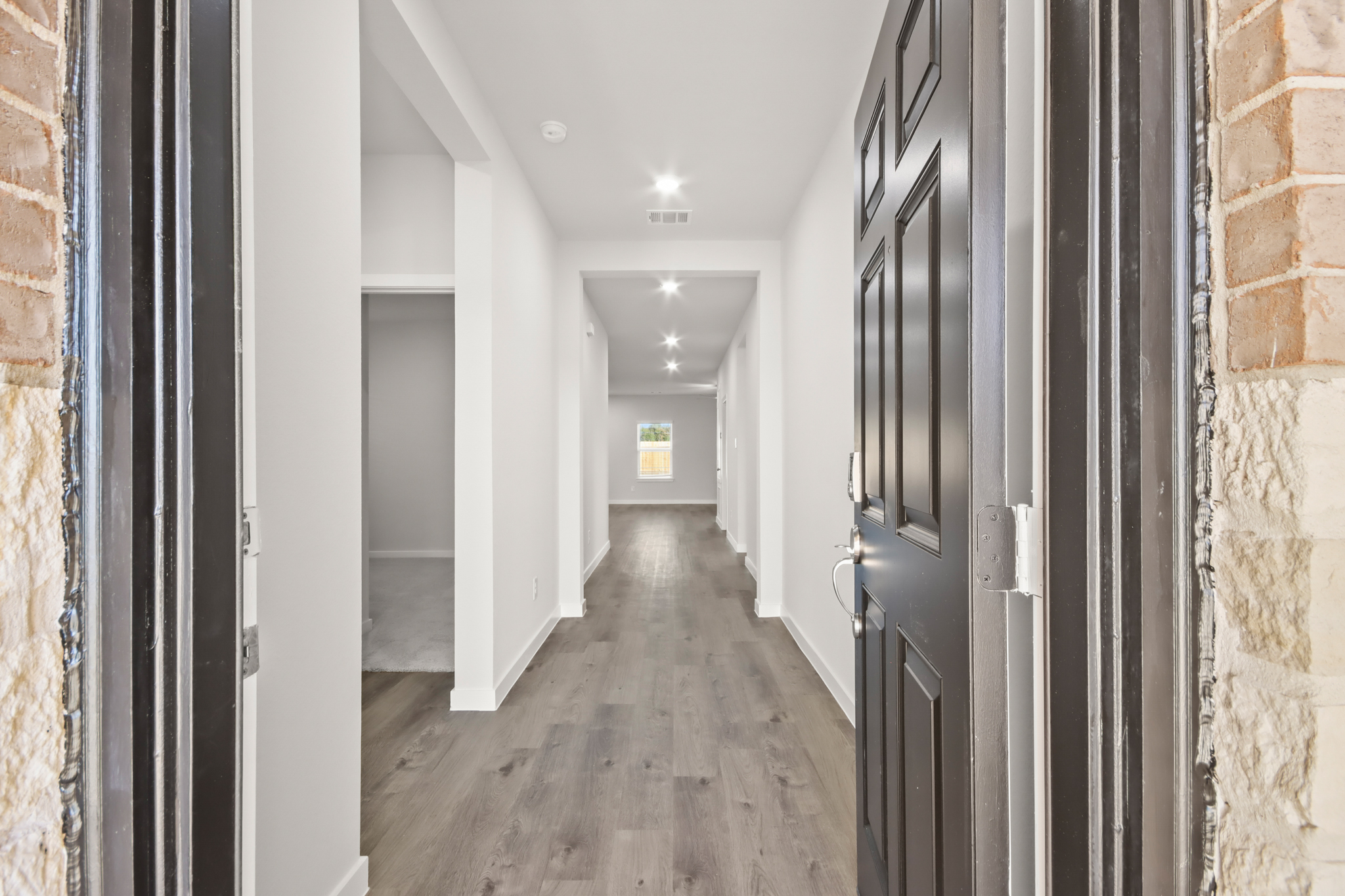 A hallway with black doors.