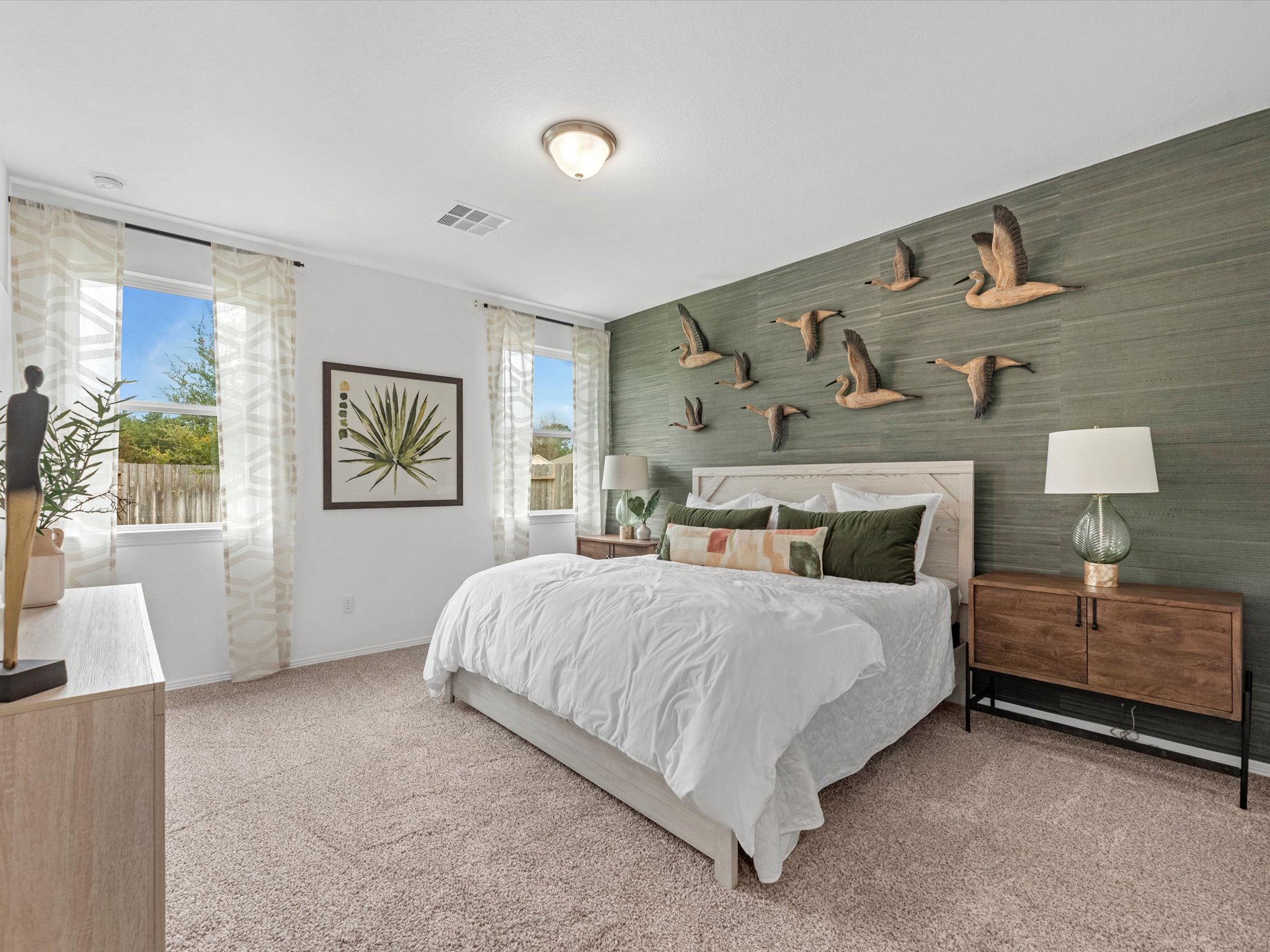 A bedroom with a bed and a lamp.