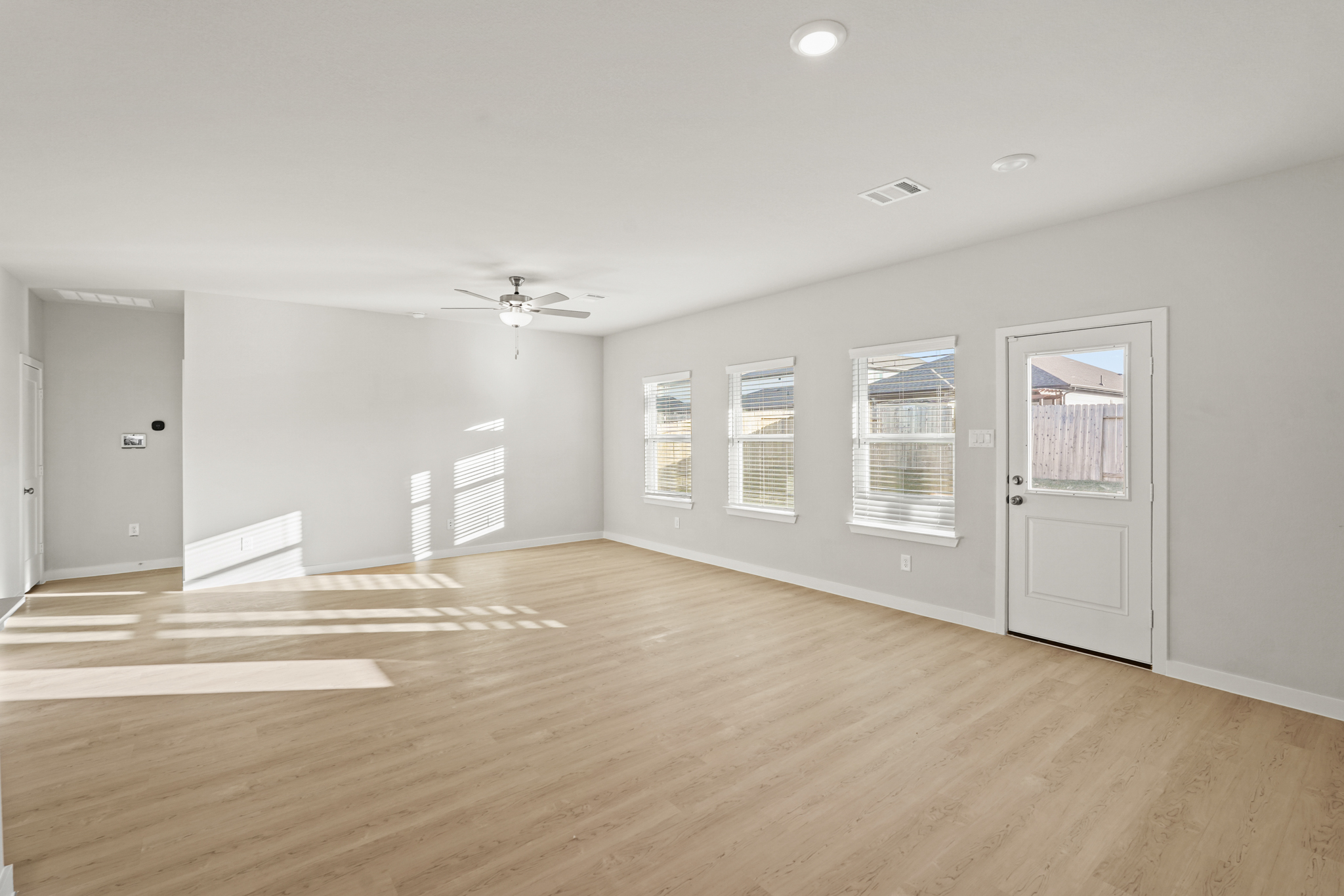A room with a wood floor and white doors.