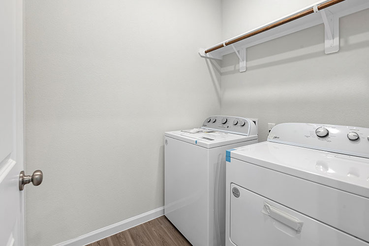 A white kitchen with a white wall.