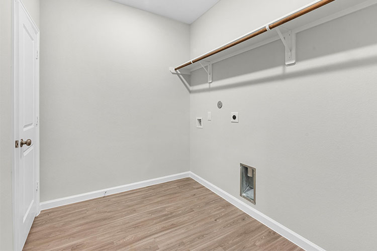 A white room with a wood floor.