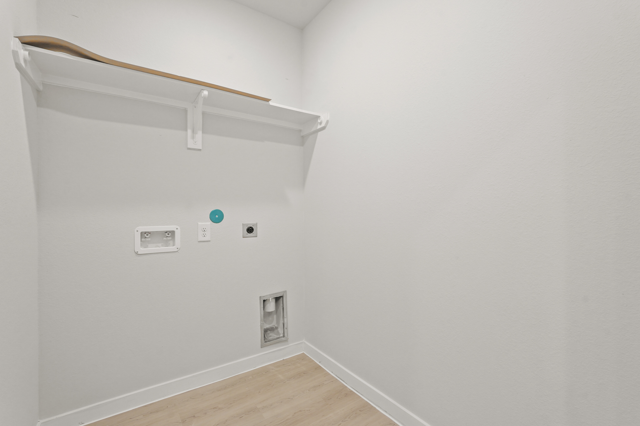 A white wall with a light fixture.