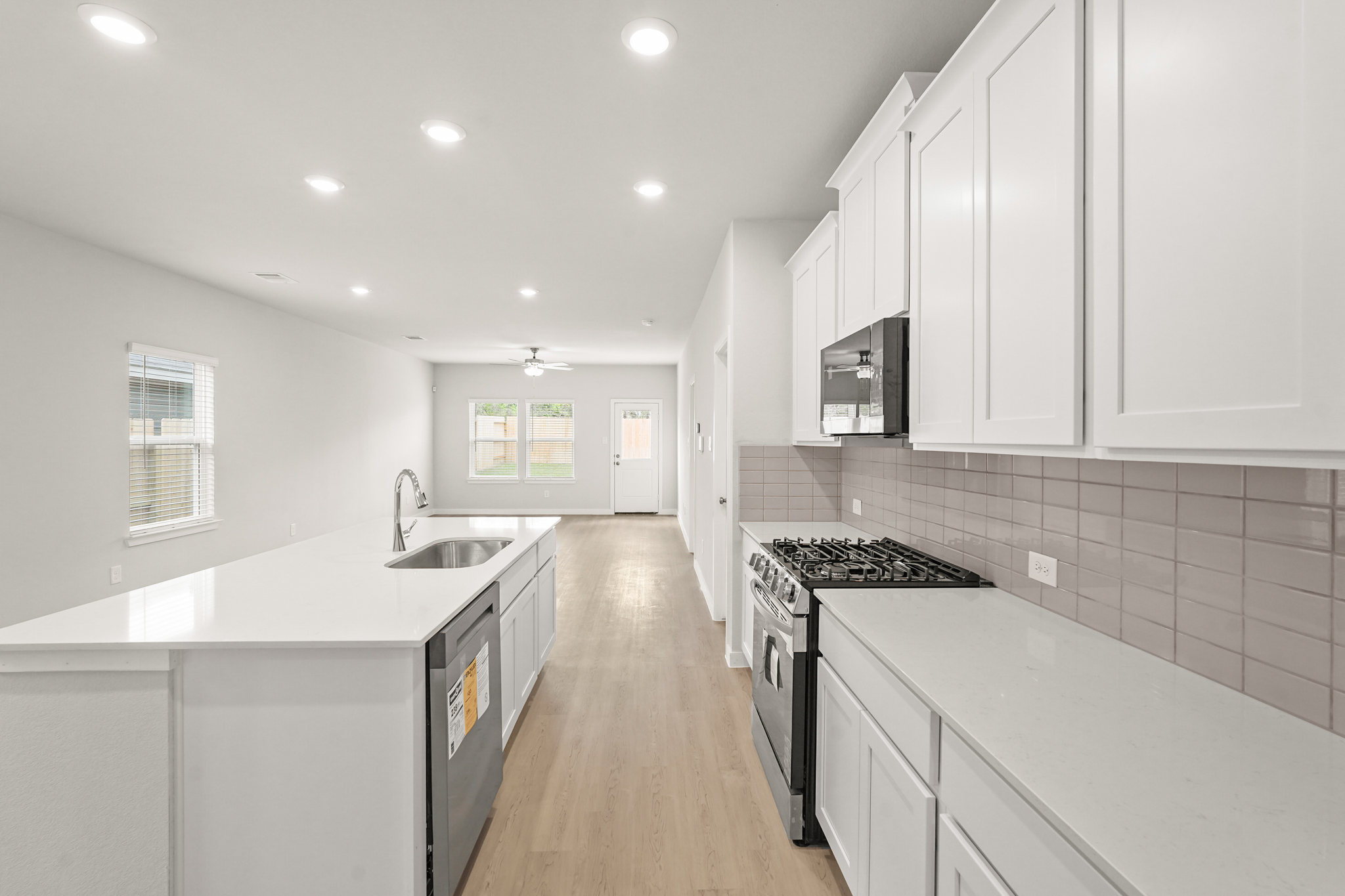 A kitchen with white cabinets.