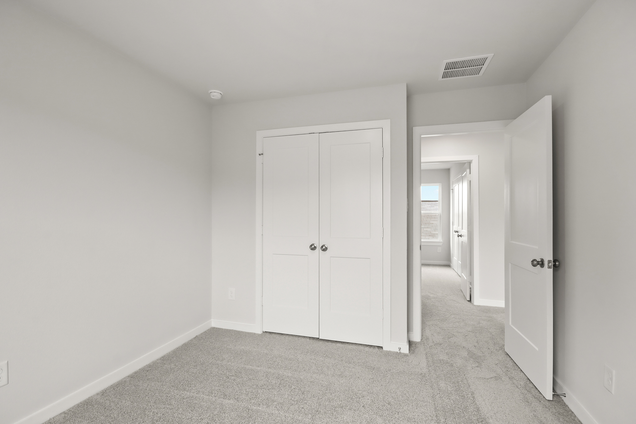 A hallway with white doors.