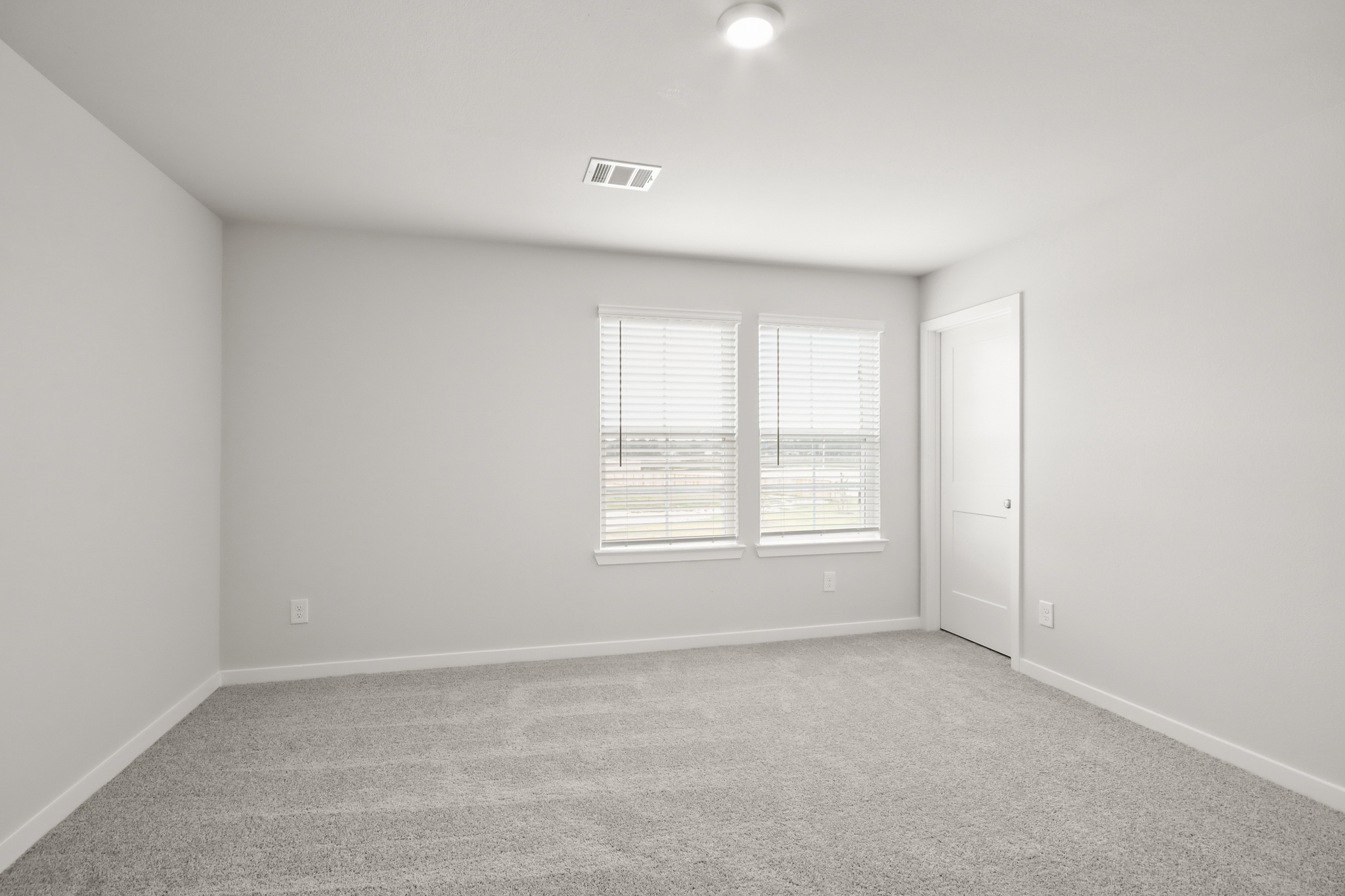 A room with a door and windows.