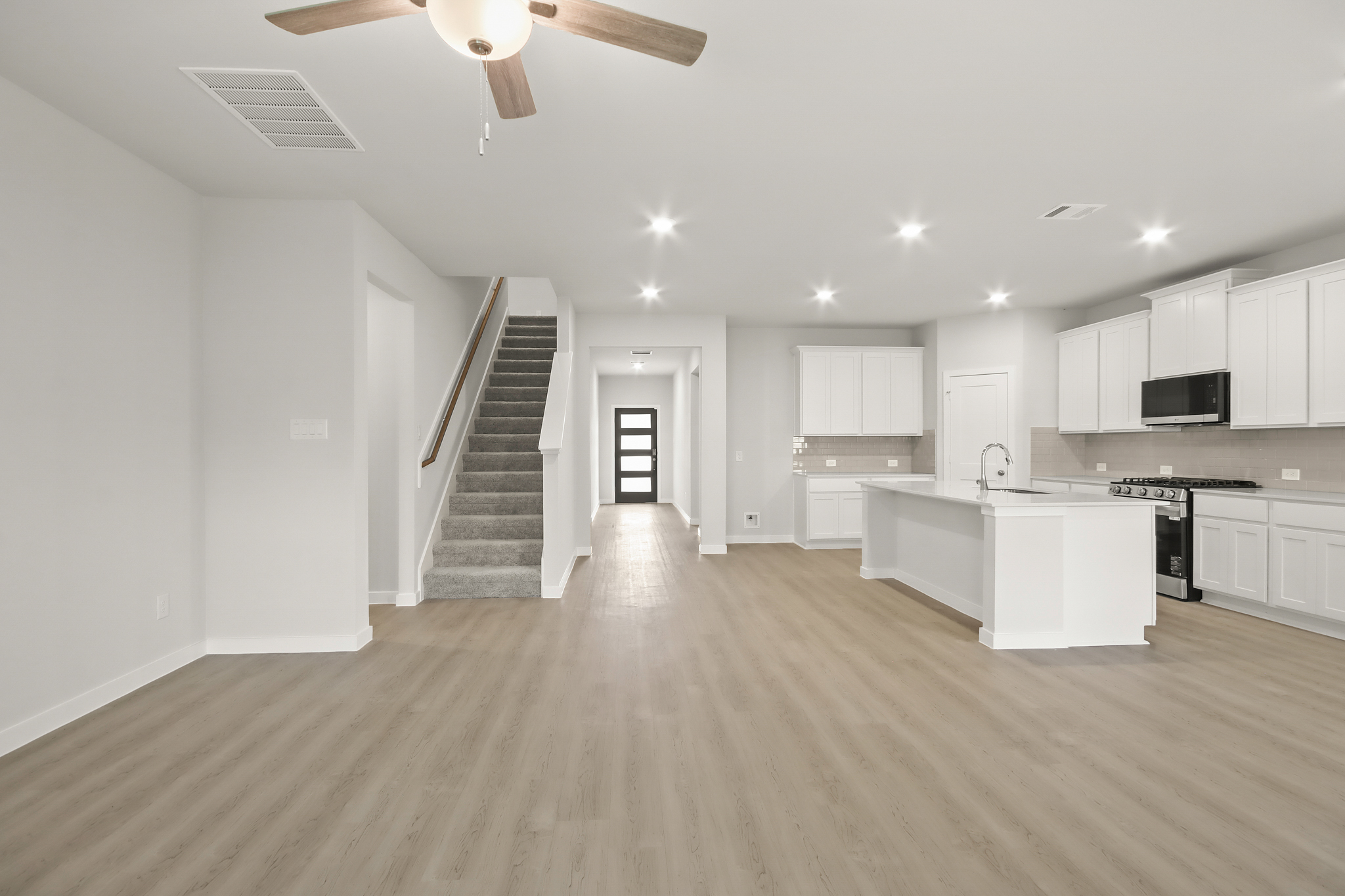 A large kitchen with white cabinets.