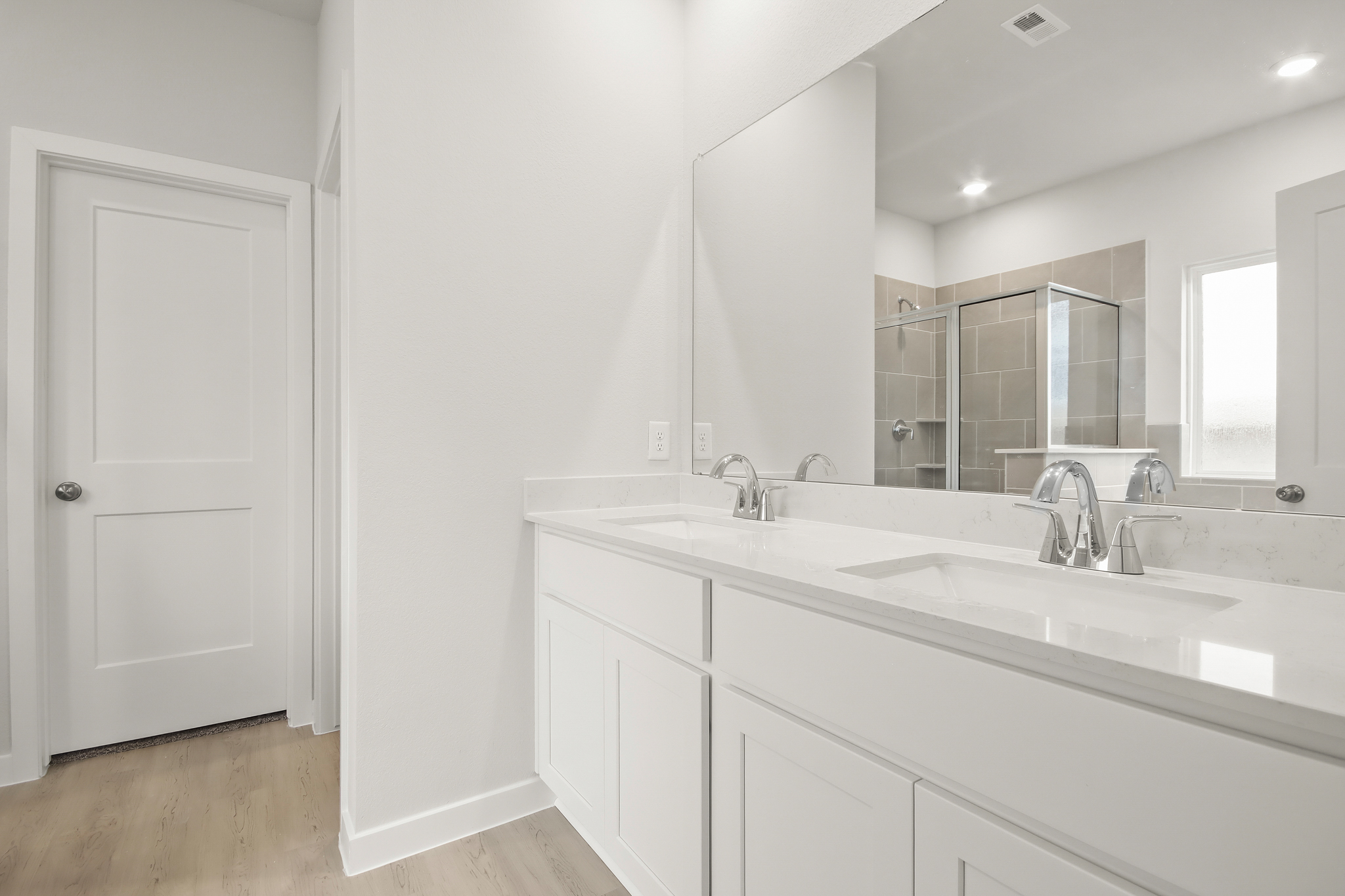 A bathroom with a large mirror.