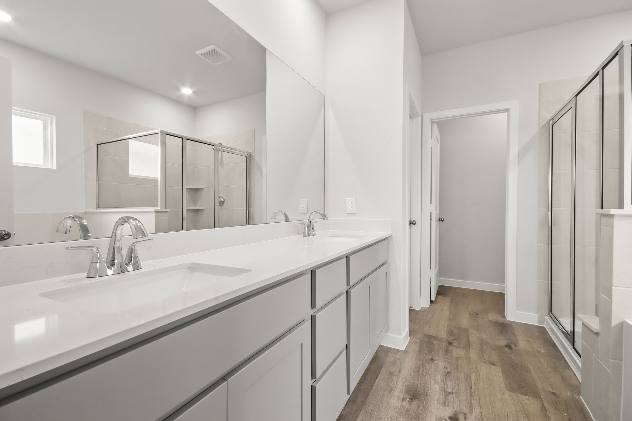 A bathroom with a large mirror.