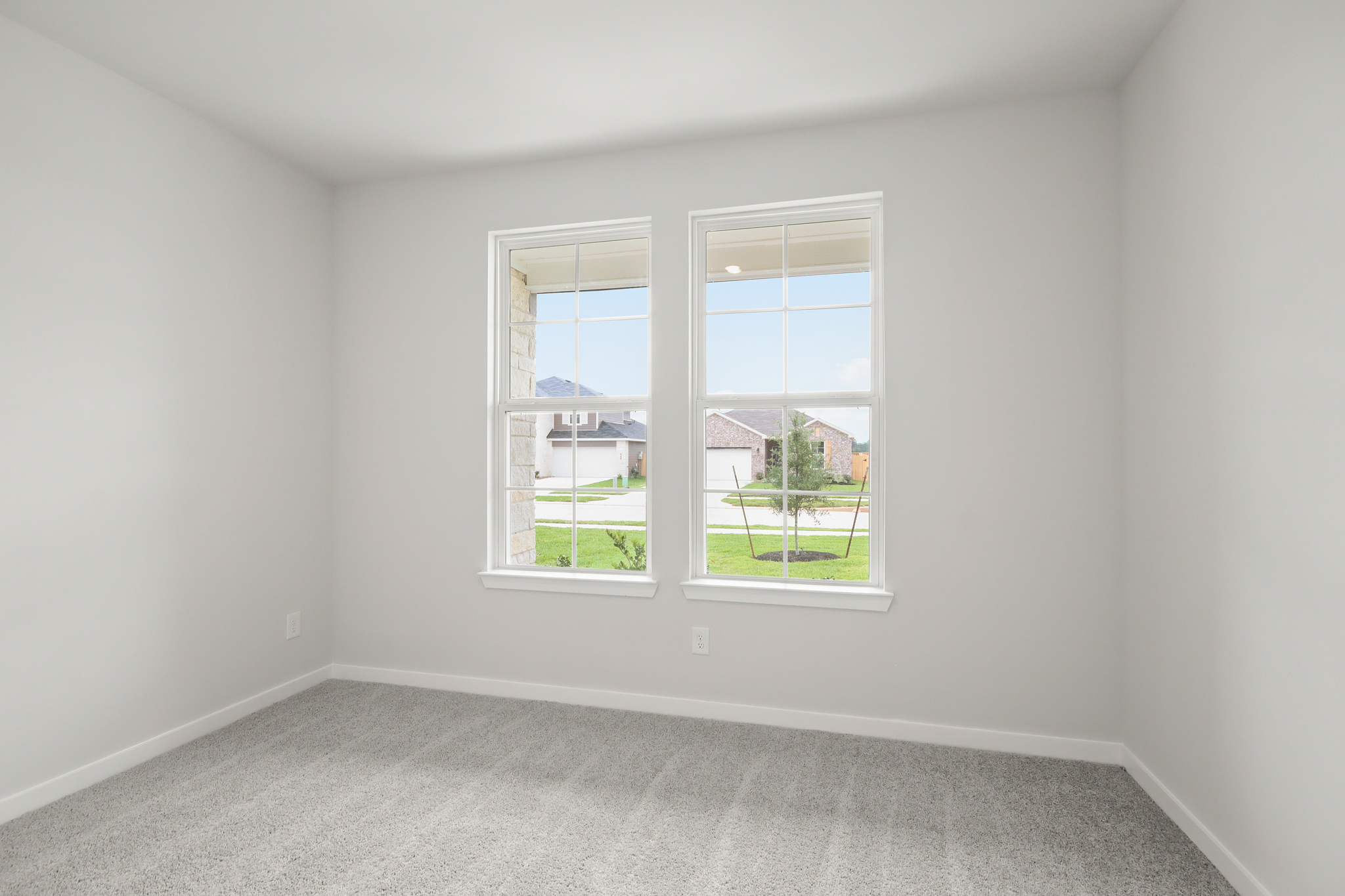 A room with a window and a carpet.